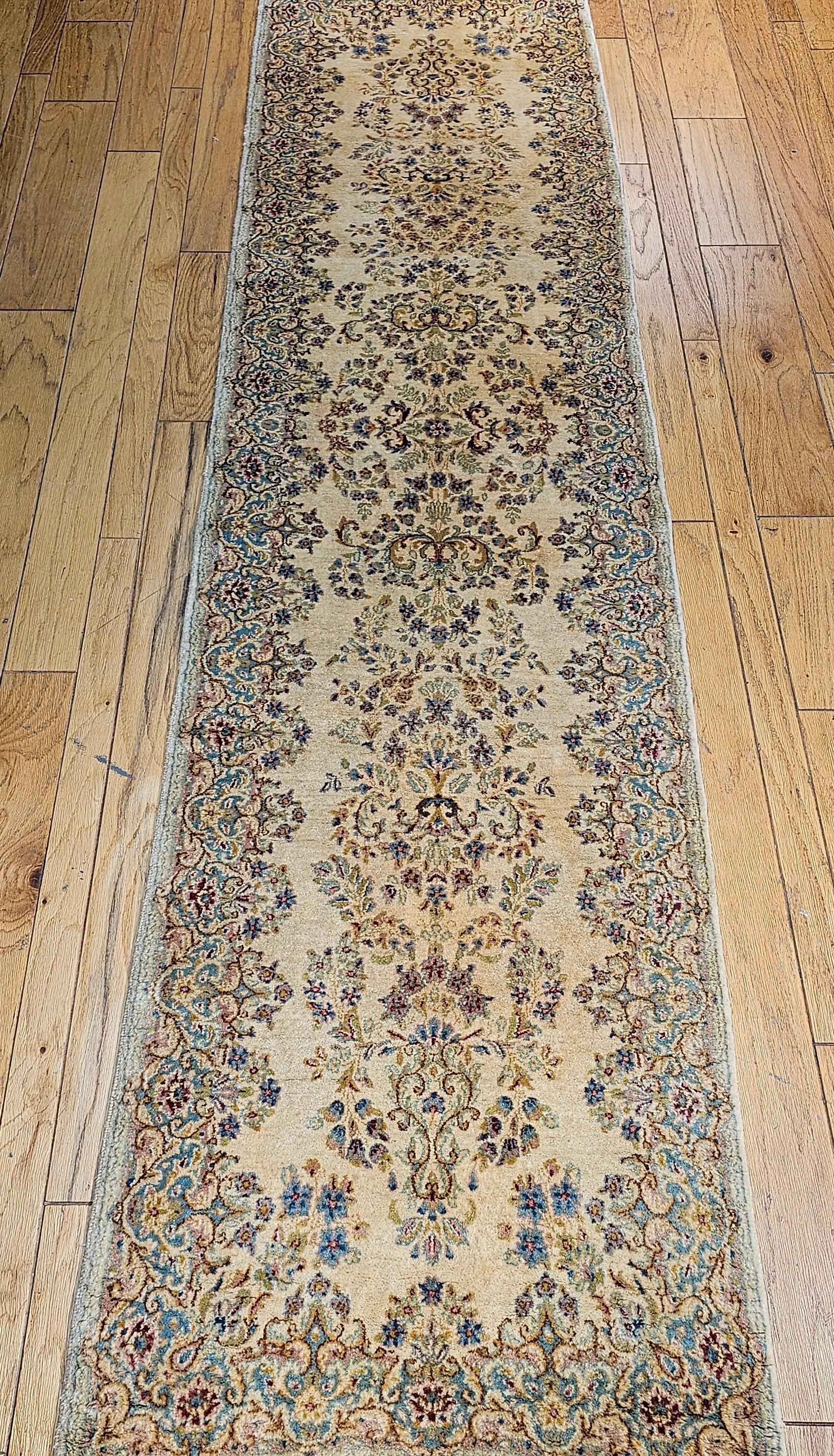 Discover the refined elegance of this captivating Vintage Persian Kerman Runner, a testament to the celebrated weaving artistry of Southern Persia. Kerman rugs are highly desired worldwide for their exquisite use of lush floral bouquets within their