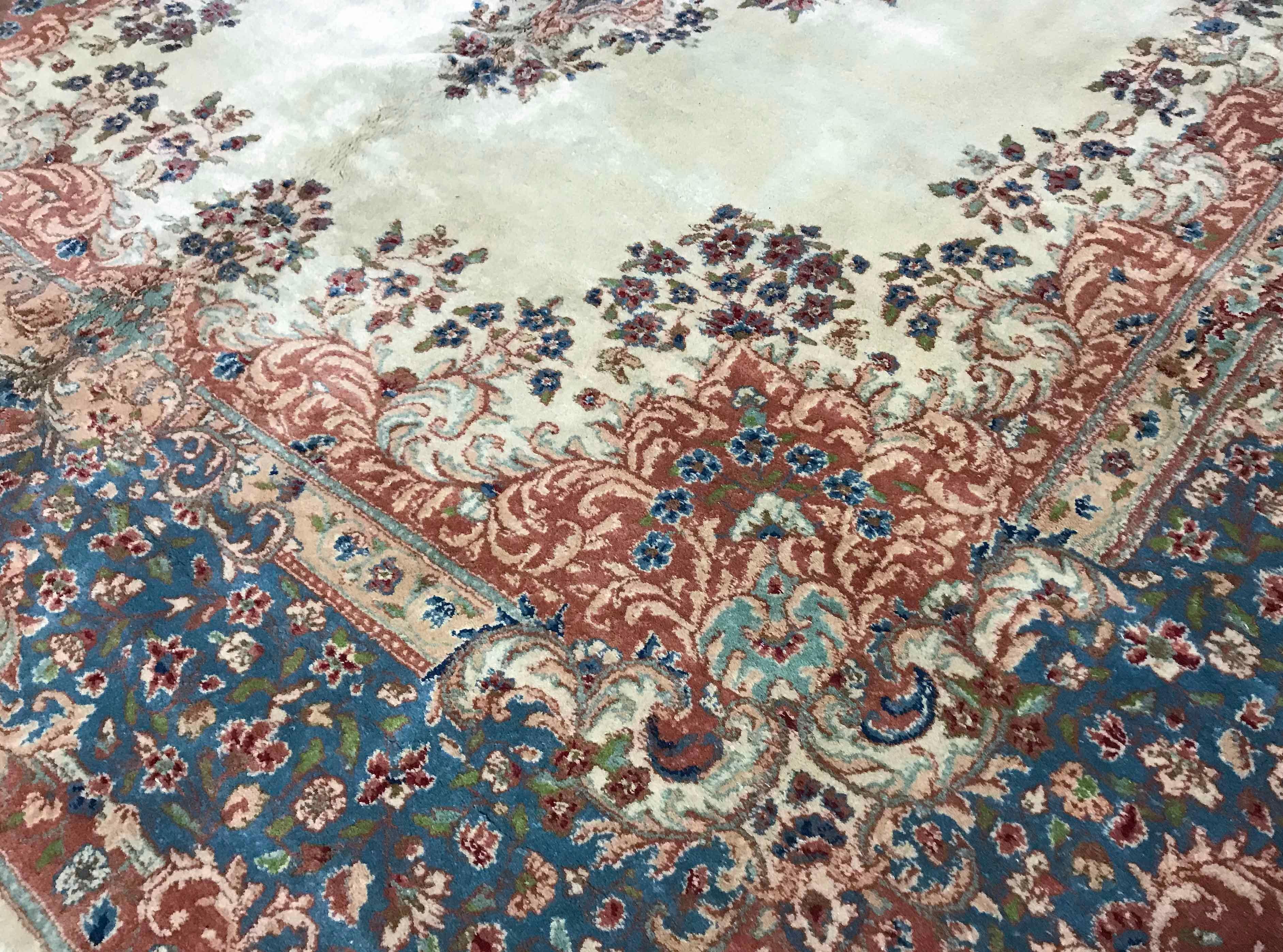 Vintage Persian Kerman, circa 1940. This attractive oversized Kerman has an ivory ground enclosing a central floral design in soft pastel blues with a floral theme surrounding the central field; the main border continues the soft blue colors and