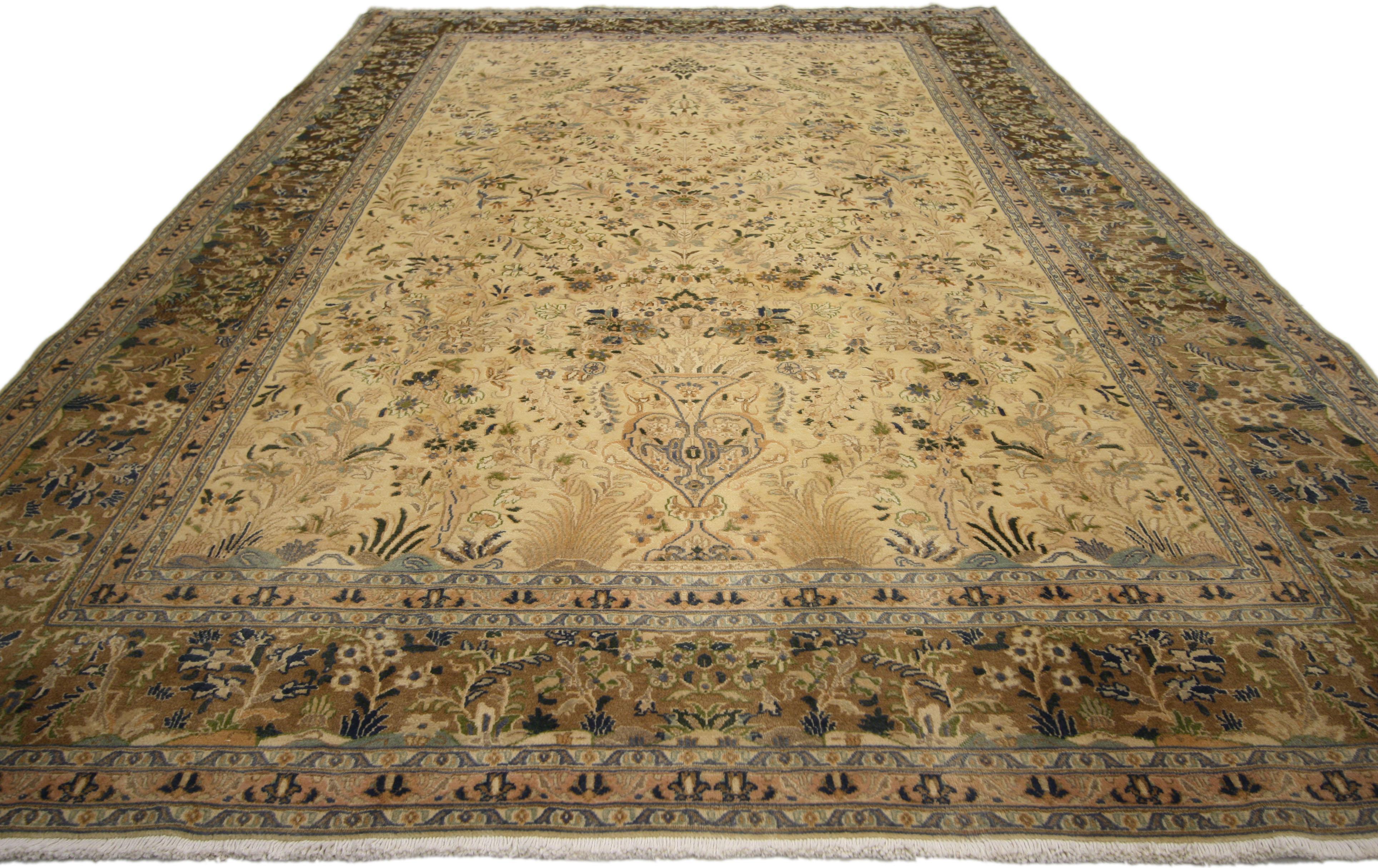 76564, vintage Persian Khorassan area rug with traditional style. Emanating grace and Persian culture, this hand knotted wool vintage Persian Khorassan area rug displays a densely ornamented field with elegant floral sprays throughout. A single vase
