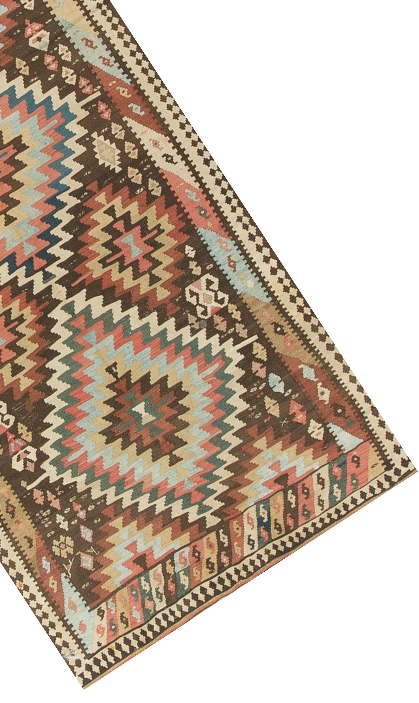 Vintage Persian Kilim circa 1930. A vintage Persian hand woven Kilim that although it has a traditional design has a modern feel today. Size: 5'1 x 9'9