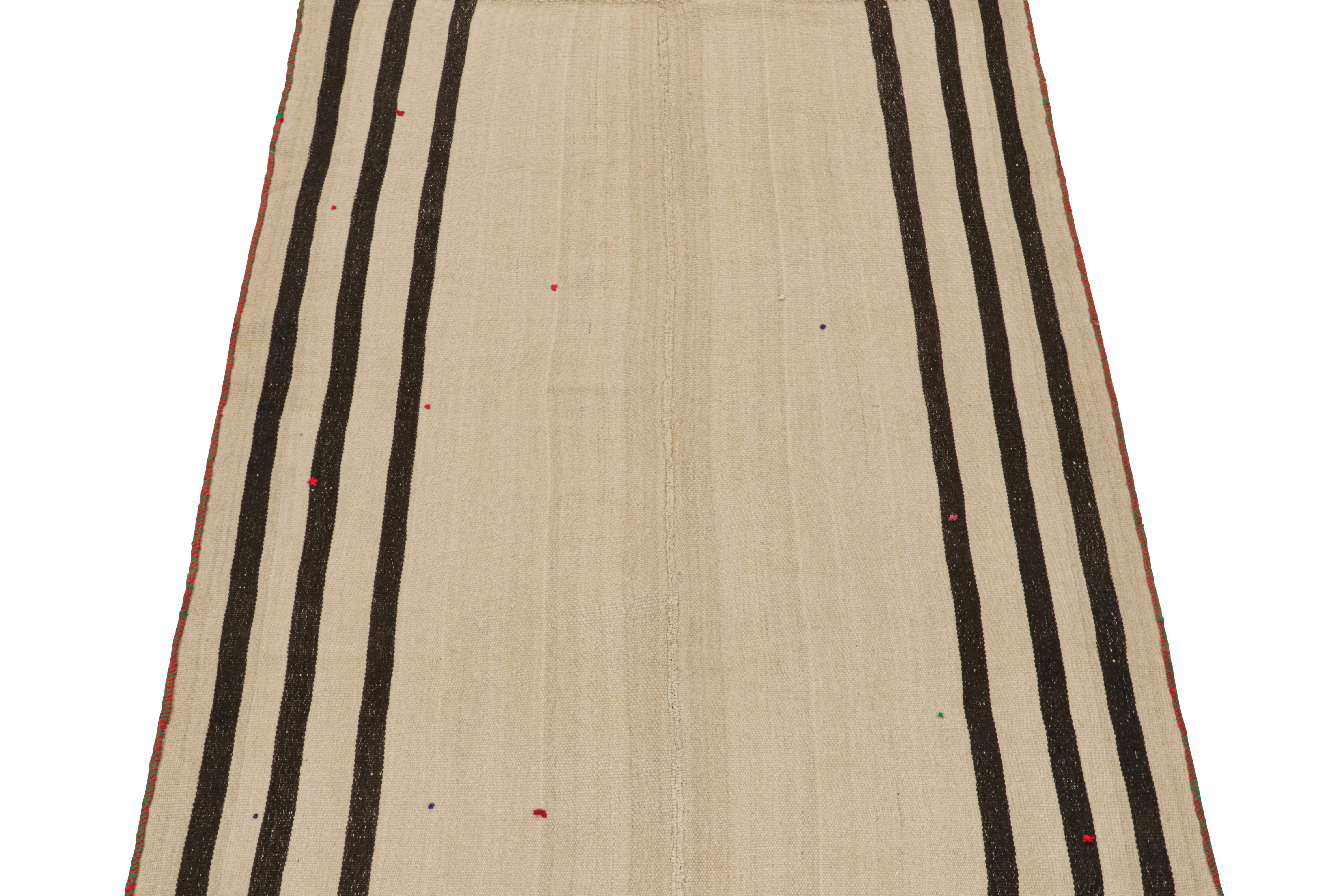 This vintage 5x8 Persian Kilim is a midcentury tribal rug, handwoven in wool circa 1950-1960. 

Its design most likely represents a Jajim-style Kilim–a flat-weaving technique in which multiple pieces are combined into one. This creates the look of