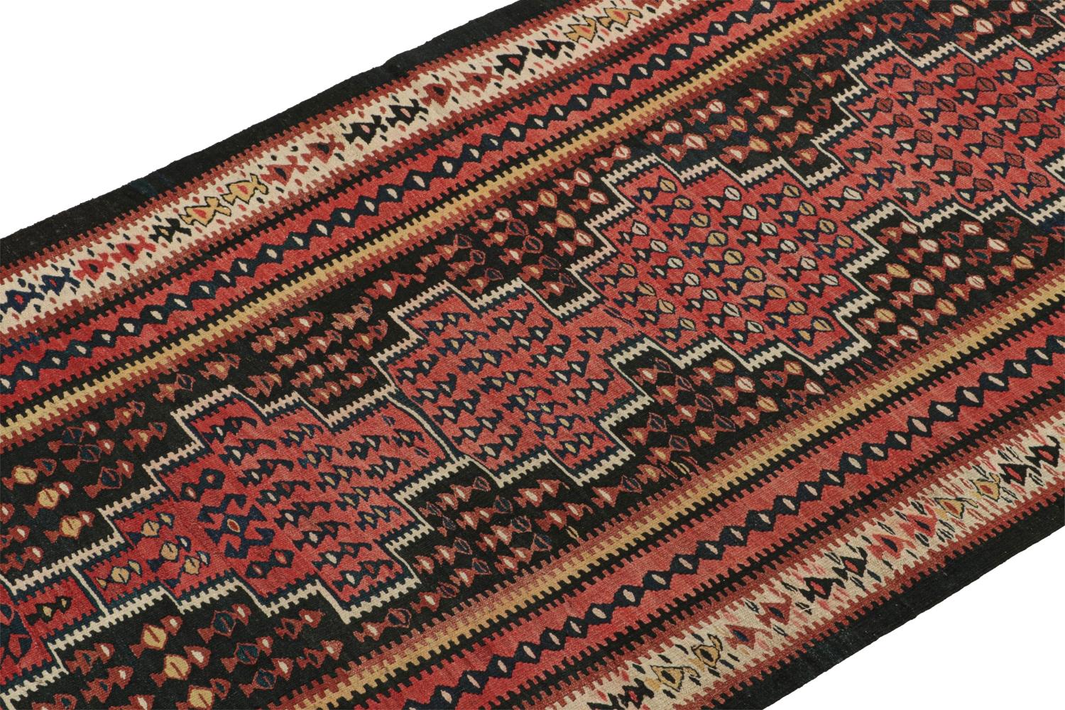 This vintage 4x11 Persian Kilim is a midcentury tribal rug that we believe originates from Harsin in the Kermanshah province. 

On the Design:

Handwoven in wool circa 1950-1960, its design enjoys finely detailed tribal geometric patterns in