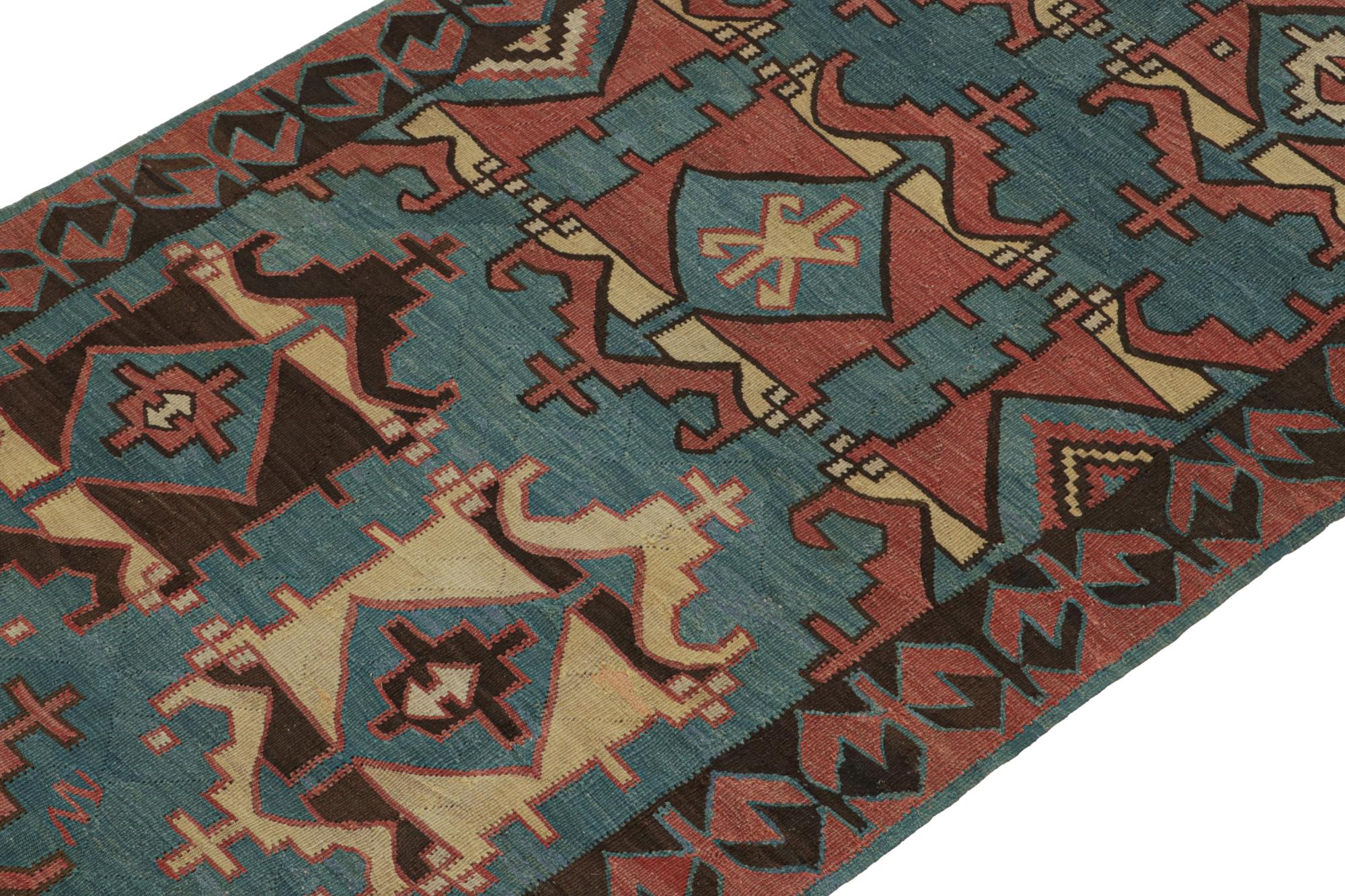 This vintage 4x9 Persian Kilim is handwoven in wool, and originates circa 1950-1960.

On the Design: 

This flat weave enjoys sharp medallions and geometric patterns in deep blue brick red with beige and chocolate notes. Connoisseurs will note