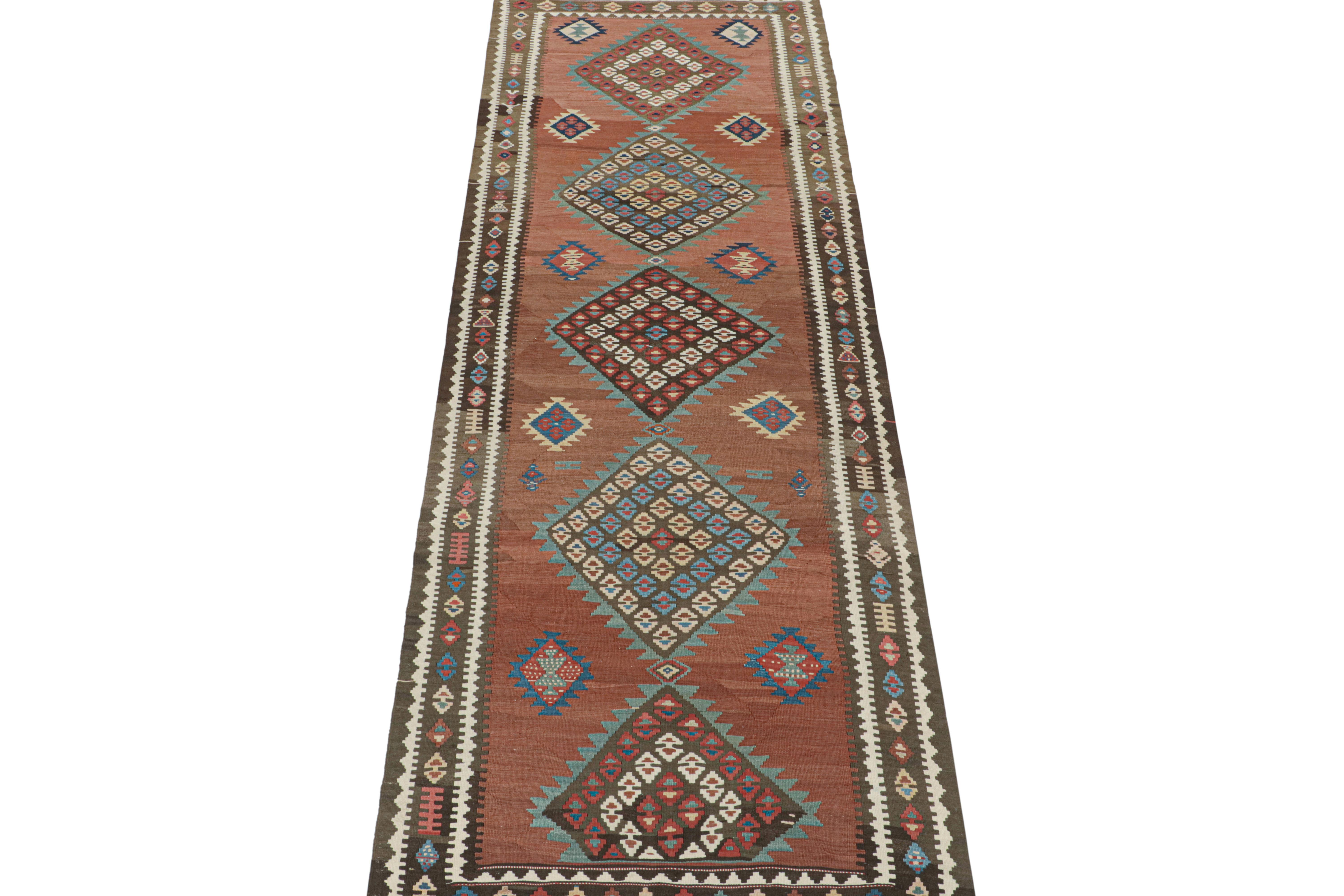 This vintage 5x14 Persian Kilim is a tribal gallery runner from Meshkin—a small northwestern village known for its fabulous works. Handwoven in wool, it originates circa 1950-1960. 

On the Design:

Its design favors a polychromatic approach to