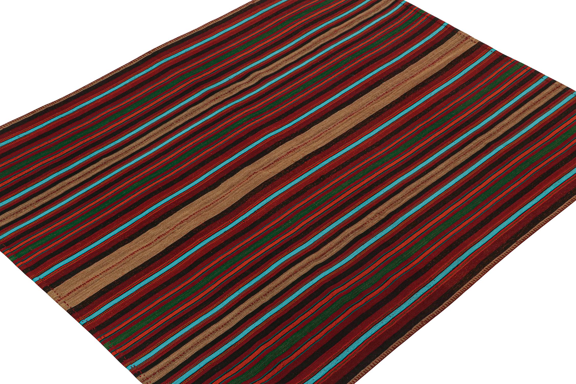 This vintage 6 x 7 Persian kilim is a mid-century tribal rug, handwoven in wool circa 1950-1960.

The design enjoys stripes alternating in tones of bright blue, green, black, and beige-brown on a burgundy red base. Its technique, connoisseurs will