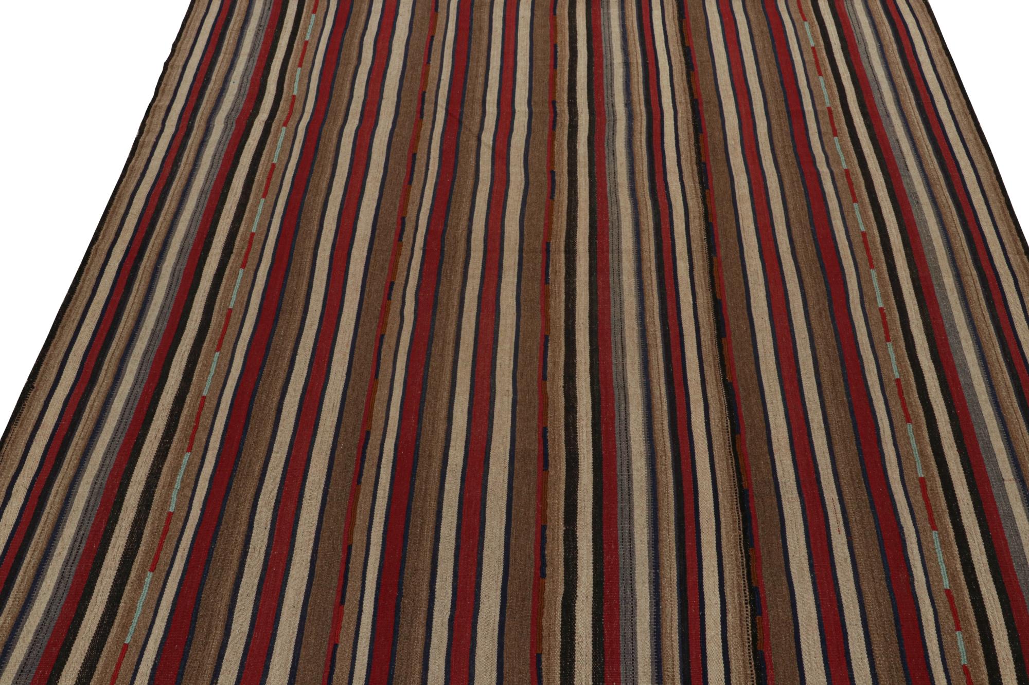 This vintage 8x9 Persian Kilim is handwoven in wool, and originates circa 1950-1960.

On the Design: 

Flatweave enjoys an all-over pattern with stripes in rich red, beige-brown and blue tones.
This is a comfortable choice with vast