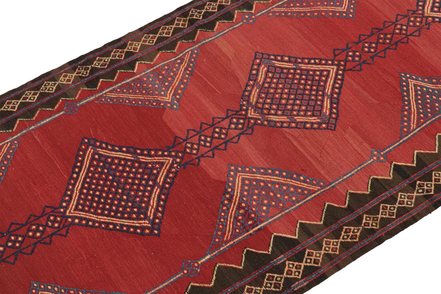 This vintage 5x14 Persian kilim is a mid-century tribal rug believed to originate from the Khalkhal village in Azerbaijan.

On the Design: 

Handwoven in wool, this flatweave enjoys a saturated red open field with blue geometric patterns and a