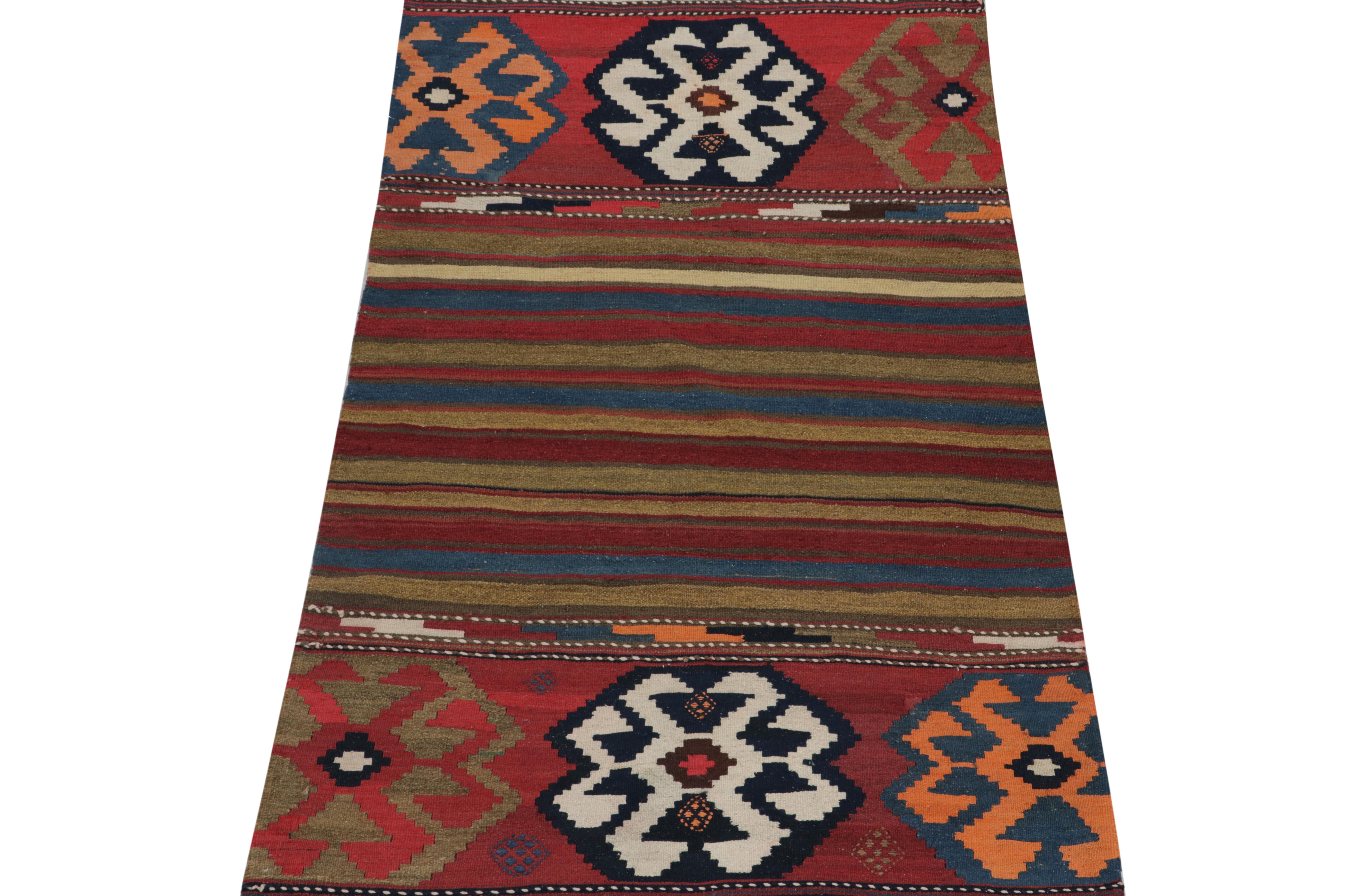 This vintage 3x6 Persian kilim is a unique tribal runner for its period, handwoven in wool circa 1950-1960.

Further on the Design:

A field hosts tribal patterns & a series of horizontal stripes in polychromatic tones of red, white, black,