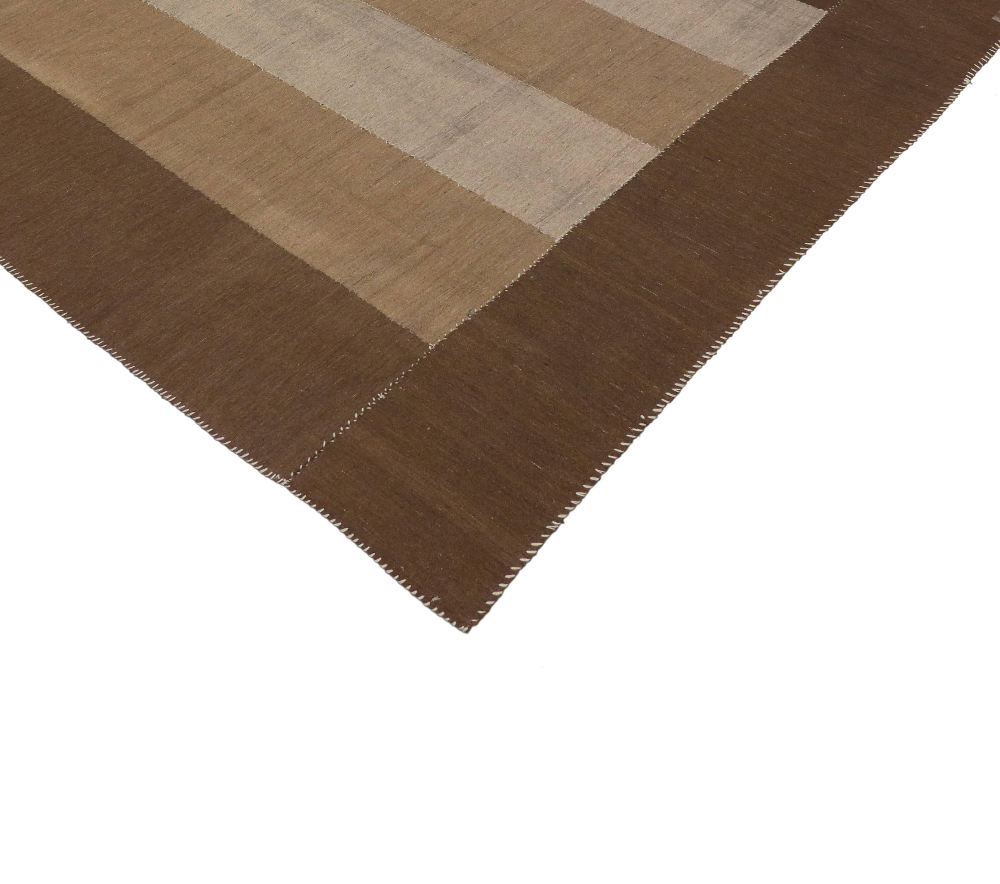 76387 vintage Persian Kilim rug with modern style. Create a comfortable and modern setting with this vintage Persian Kilim from Iran. Featuring a simplistic style and modest palette, these earthy shades of brown are excellent color combinations for
