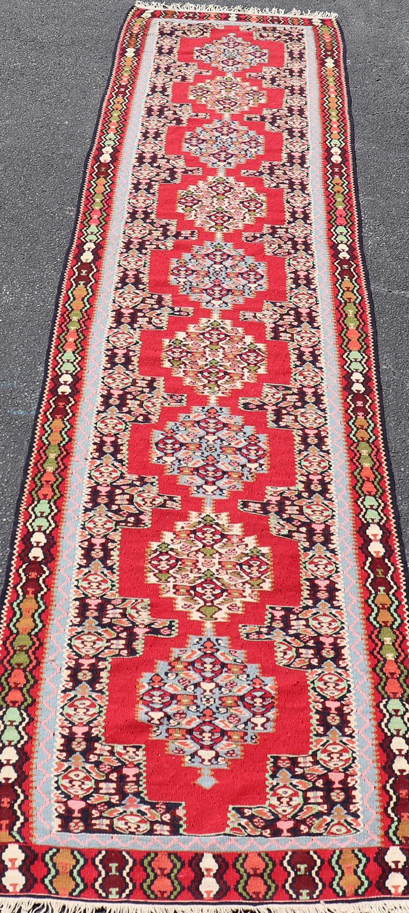 Measures: 2'7 x 12'2 
Vintage Persian Kilim Rug with Vibrant Red Field and Accents of Light 2'7 x 12'2. Keivan Woven Arts / rug/DSP-250101, country of origin / type: Iran/ Kilim, circa 1950. 

Rich in traditional design and color, this vintage