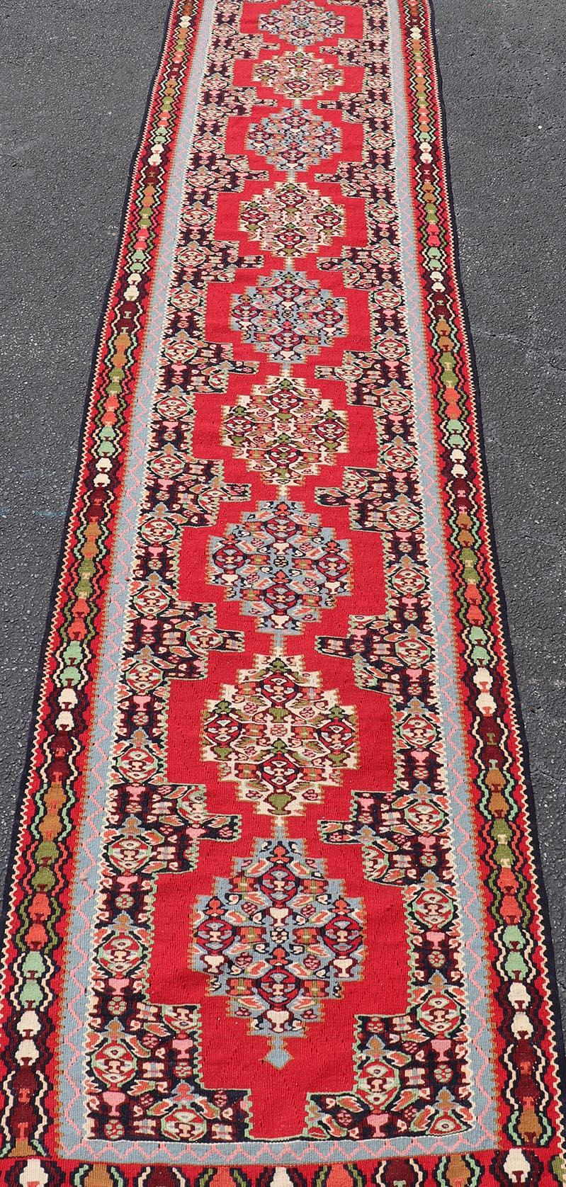 Hand-Knotted Vintage Persian Kilim Rug with Vibrant Red Field and Accents of Light 2'7 x 12'2 For Sale