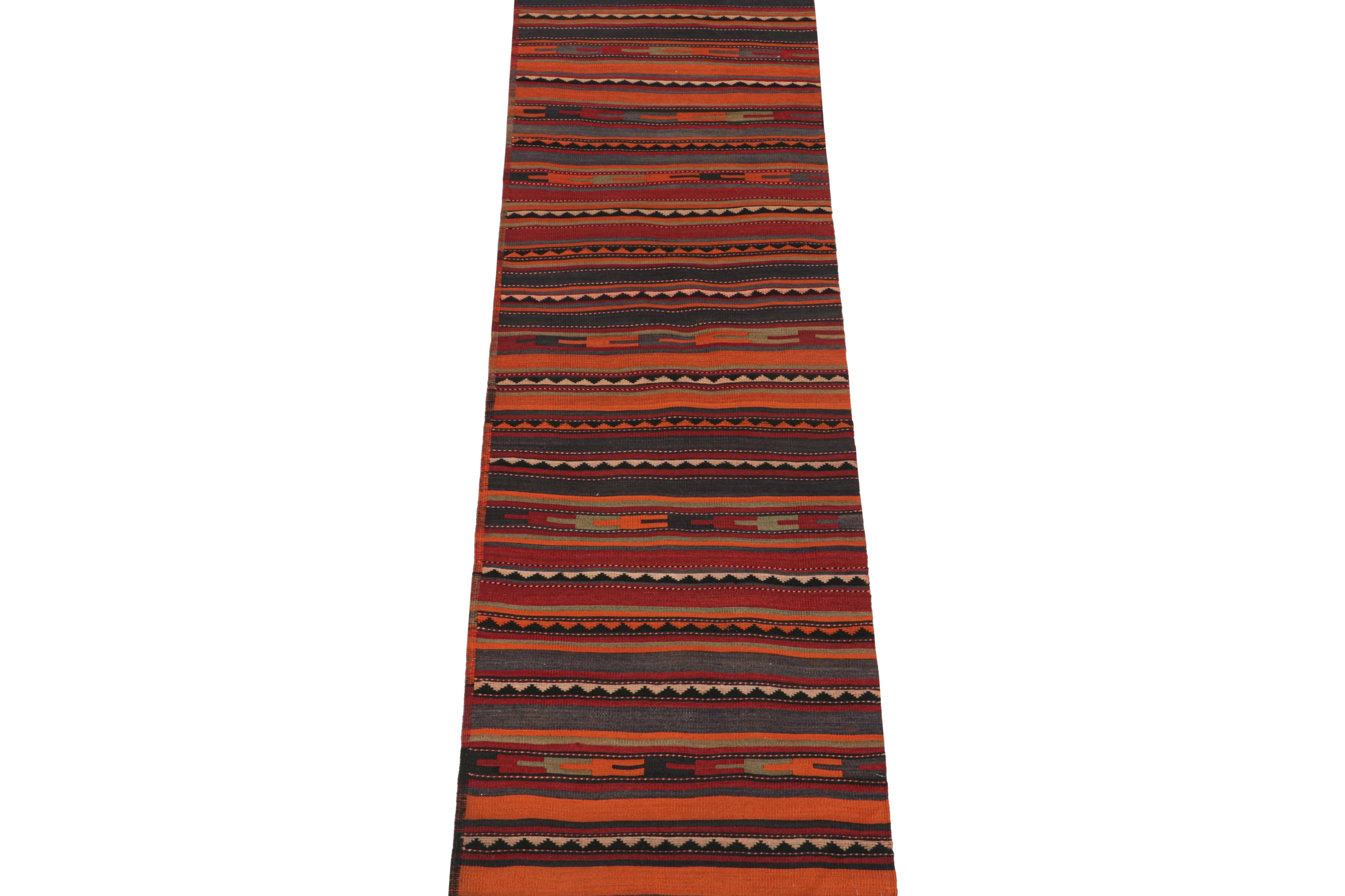 This vintage 3x10 Persian kilim is believed to be a Bidjar runner of mid-century design—handwoven in wool circa 1950-1960.

The design favors a stripes and geometric patterns over a deeply saturated orange colorway. Keen eyes will further admire