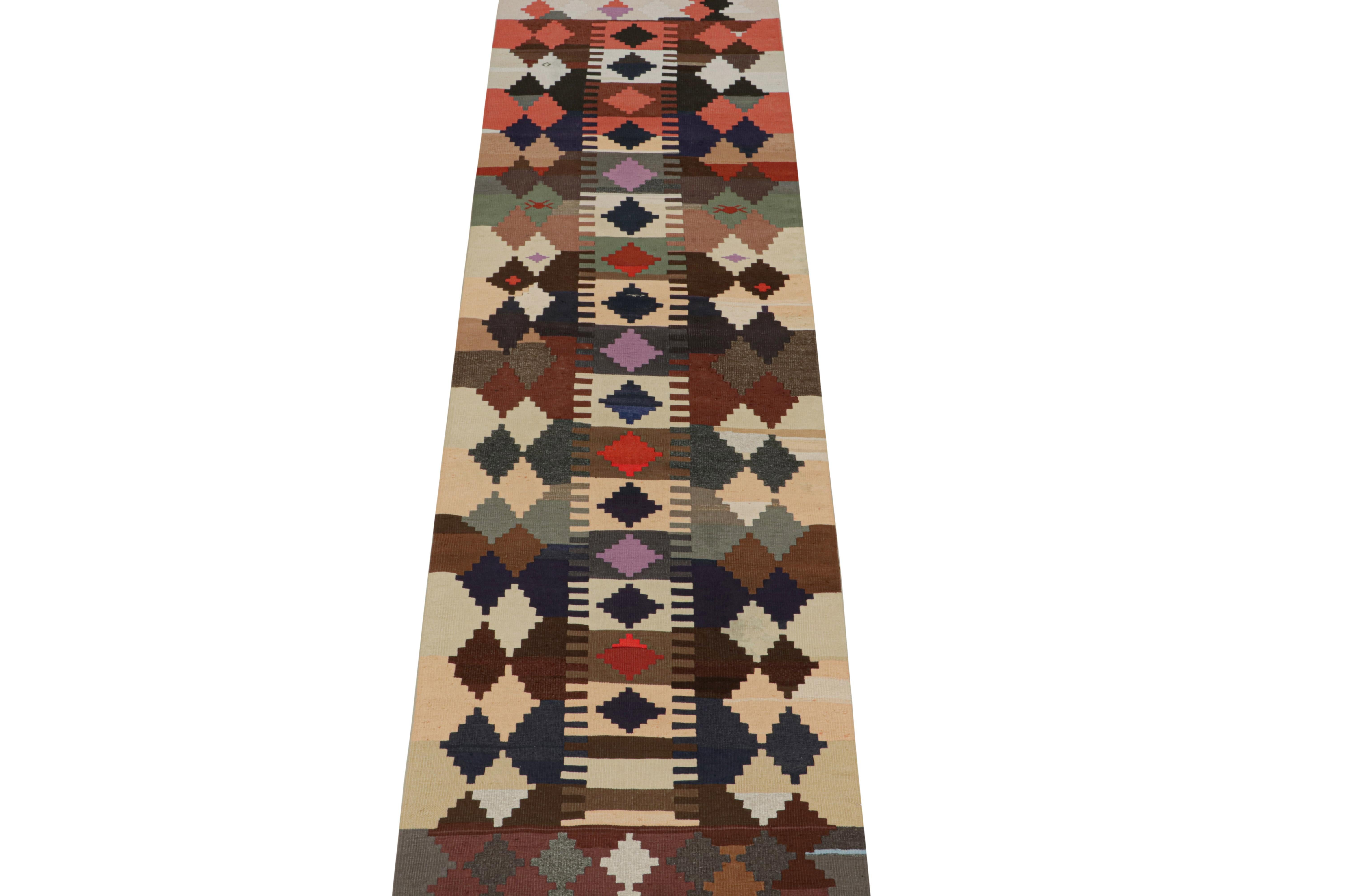This vintage 3x11 Persian kilim runner is handwoven in wool and originates circa 1950-1960. 

Further on the Design:

This design favors a vibrant polychromatic colorway and sharply woven geometric patterns—especially diamond patterns in its field.