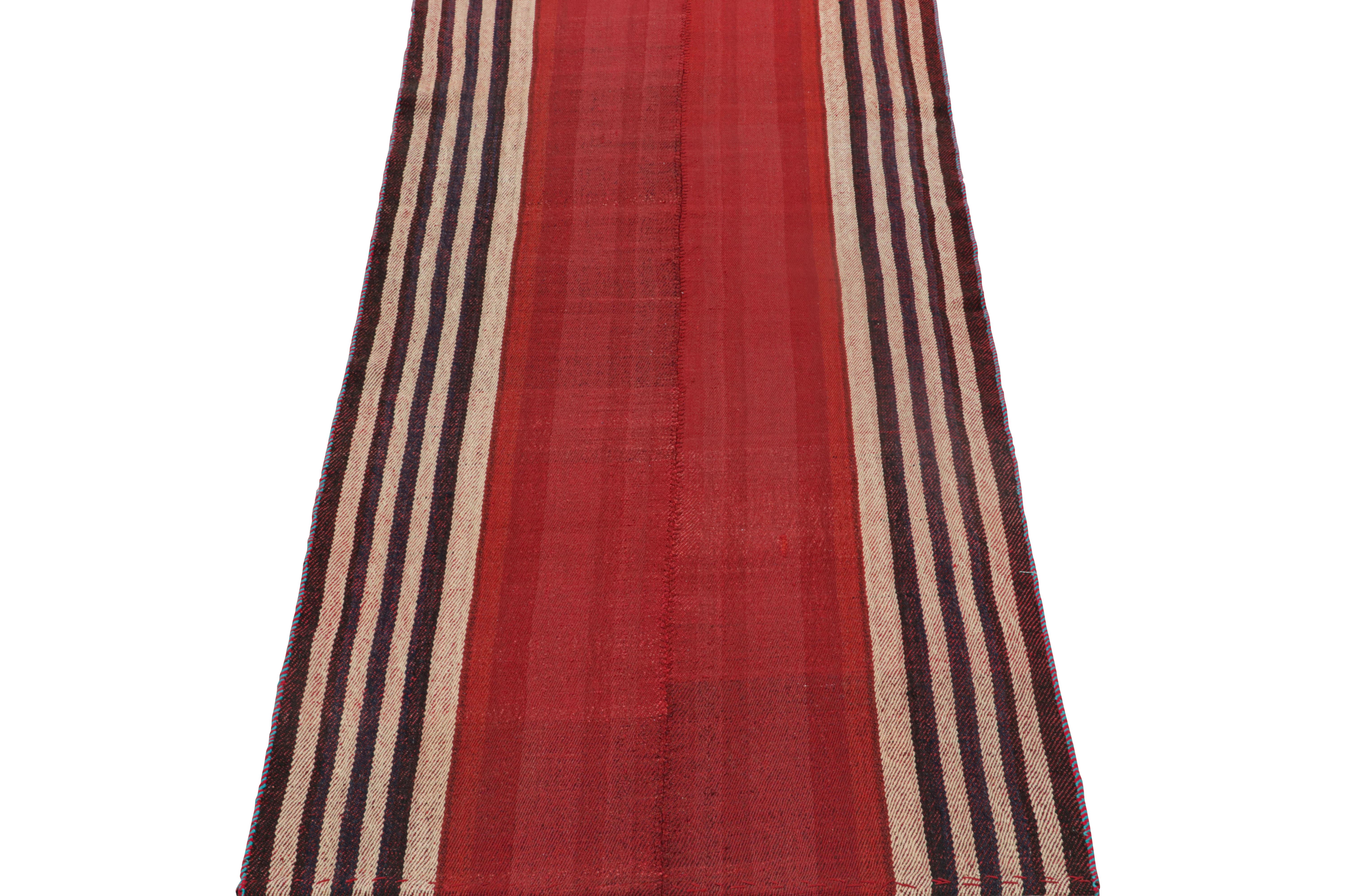 This vintage 3x7 Persian Kilim is a midcentury tribal runner, handwoven in wool circa 1950-1960. 

Its design most likely represents a Jajim-style Kilim–a flat-weaving technique in which multiple pieces are combined into one. This creates the look
