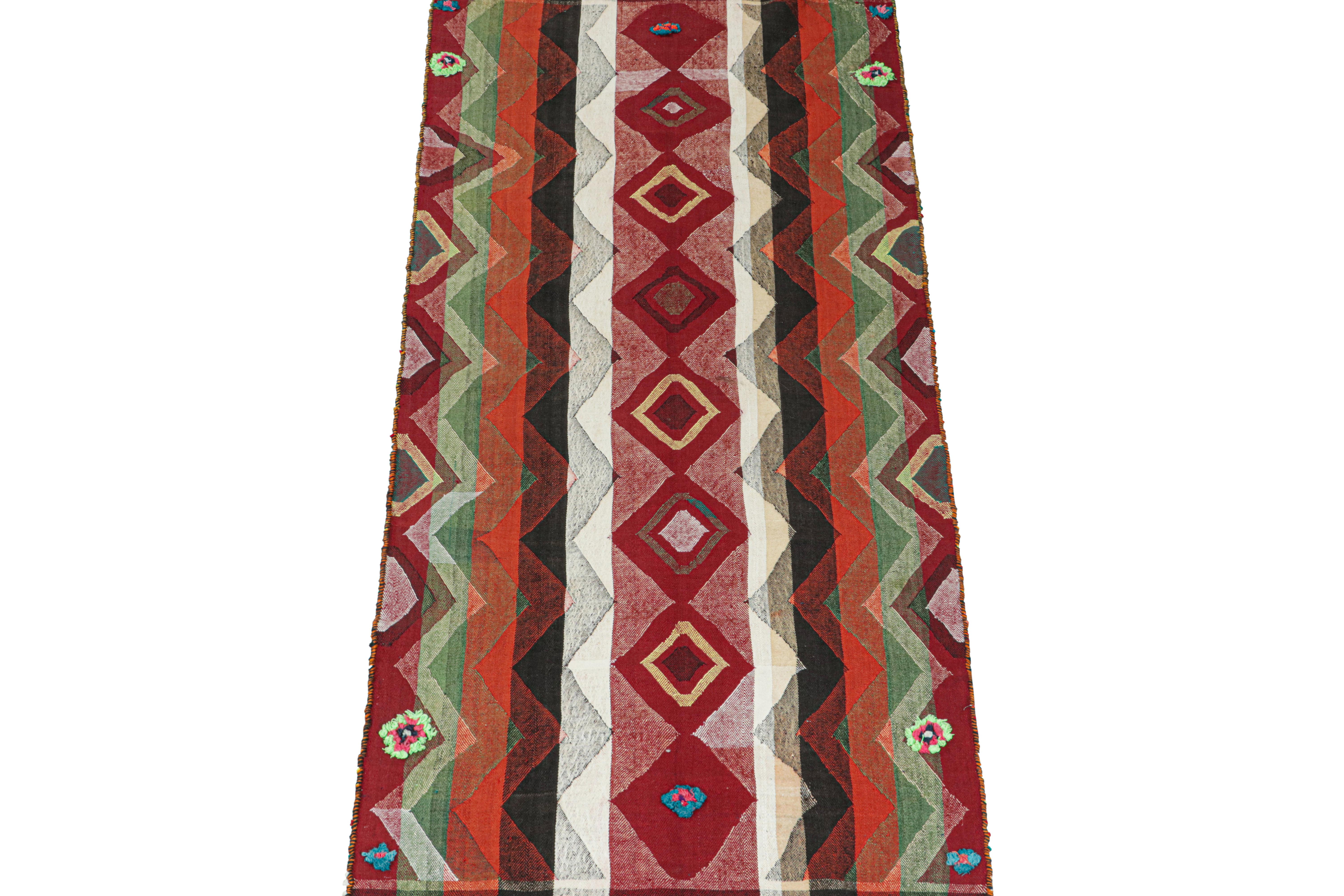 This vintage 3x8 Persian kilim runner is handwoven in wool, and originates circa 1950-1960.

Its design is a panel-weave, in which tribal weaves combine two or more flat weaves into one larger piece. This particular piece enjoys rich and vibrant