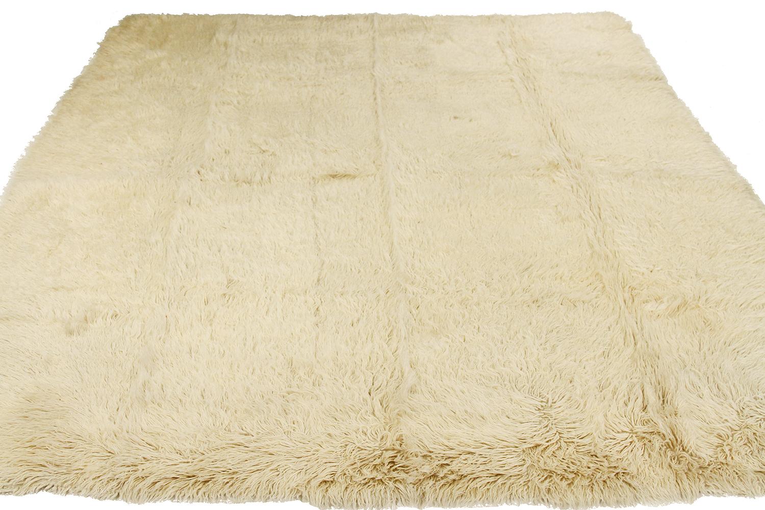 Vintage Persian rug handwoven from the finest sheep’s wool and colored with all-natural vegetable dyes that are safe for humans and pets. It’s a Kilim style design featuring an elegant and plush ivory pile. It’s a stunning piece to get for modern,