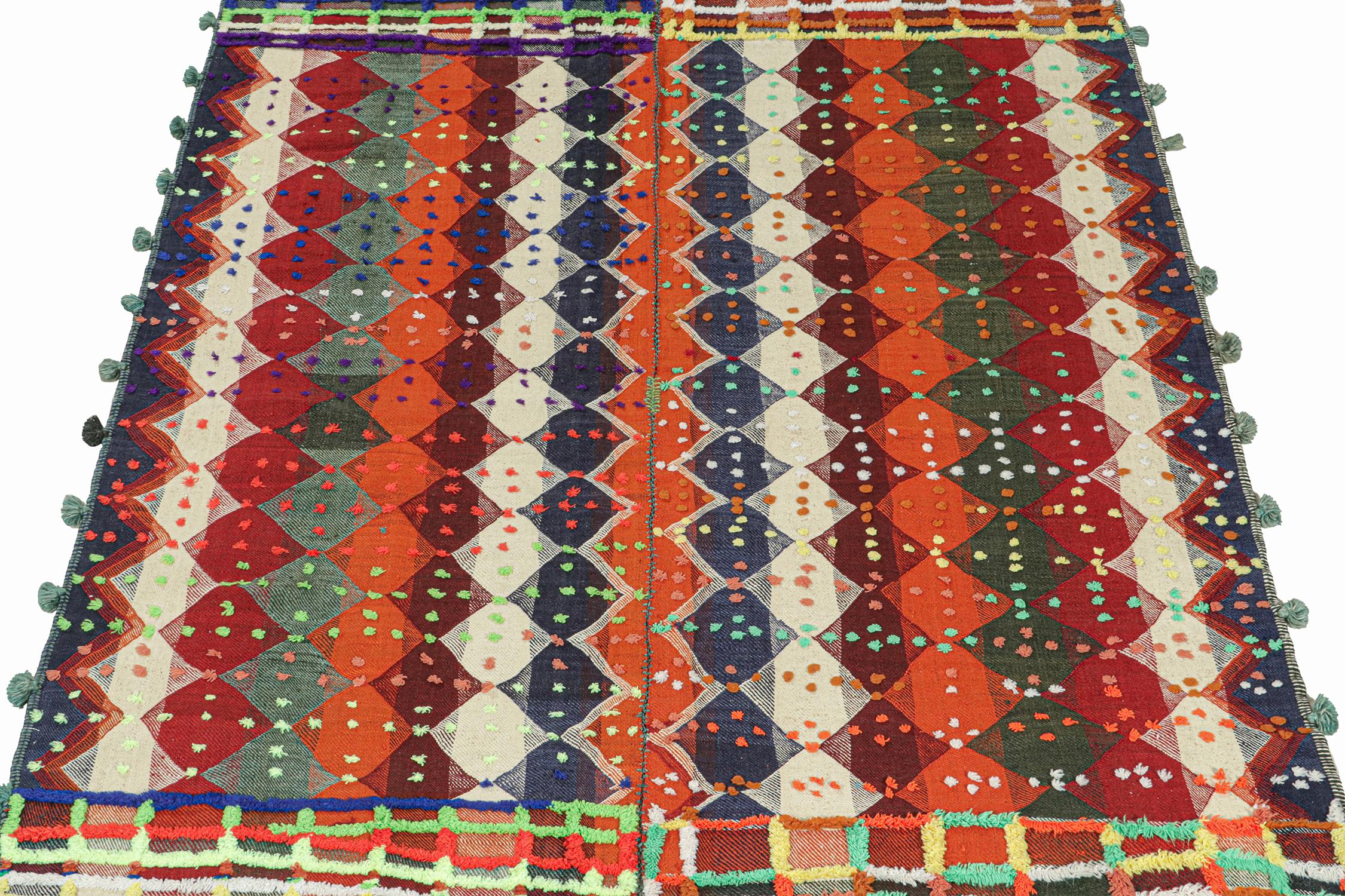 This vintage 6x9 Persian kilim rug is handwoven in wool, and originates circa 1950-1960.

Its design is a panel-weave, in which tribal weaves combine two or more flat weaves into one larger piece. This particular piece enjoys rich and vibrant