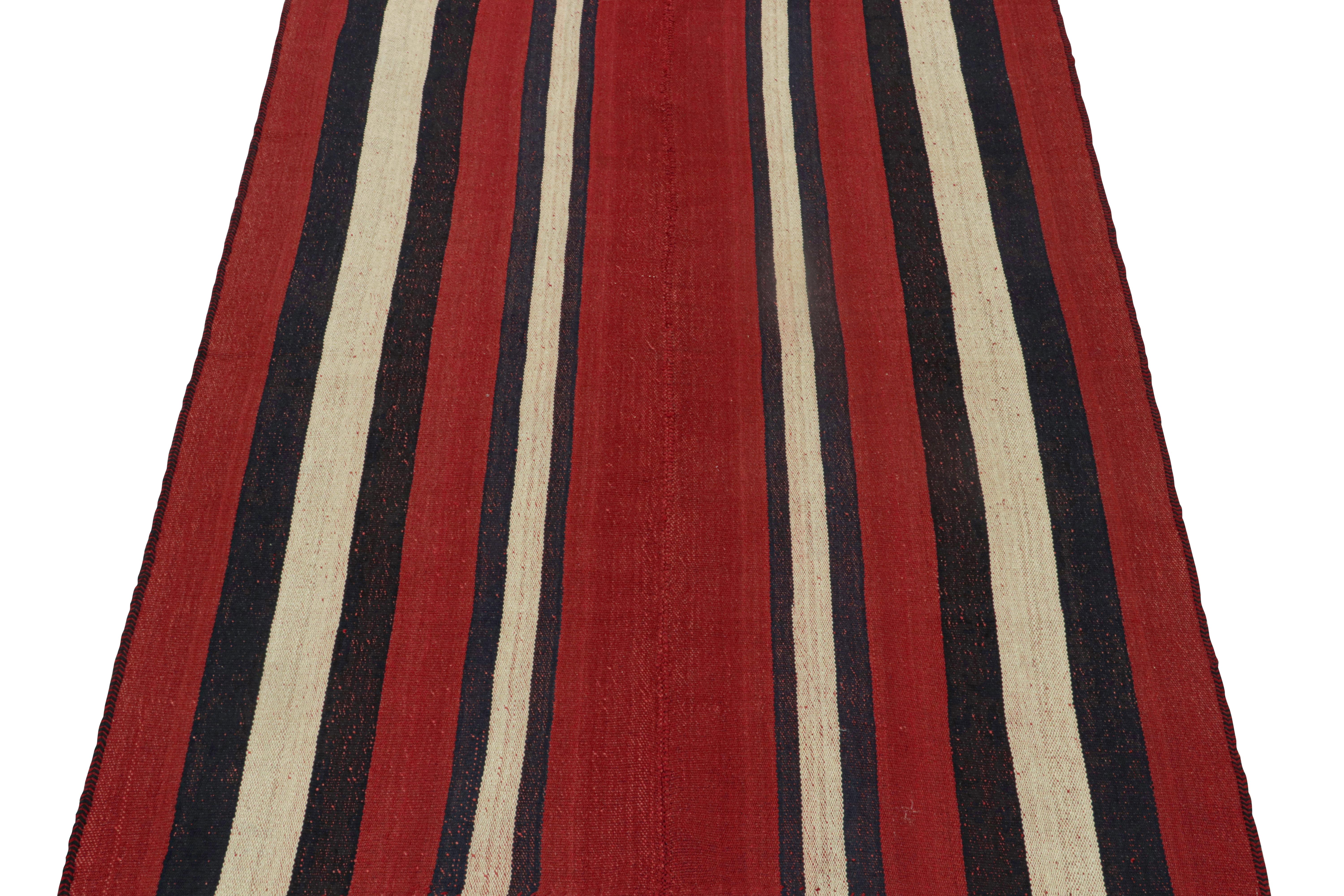 This vintage 5x7 Persian Kilim is a mid-century tribal rug, handwoven in wool circa 1950-1960. 

Its design most likely represents a Jajim-style Kilim–a flat-weaving technique in which multiple pieces are combined into one. This creates the look