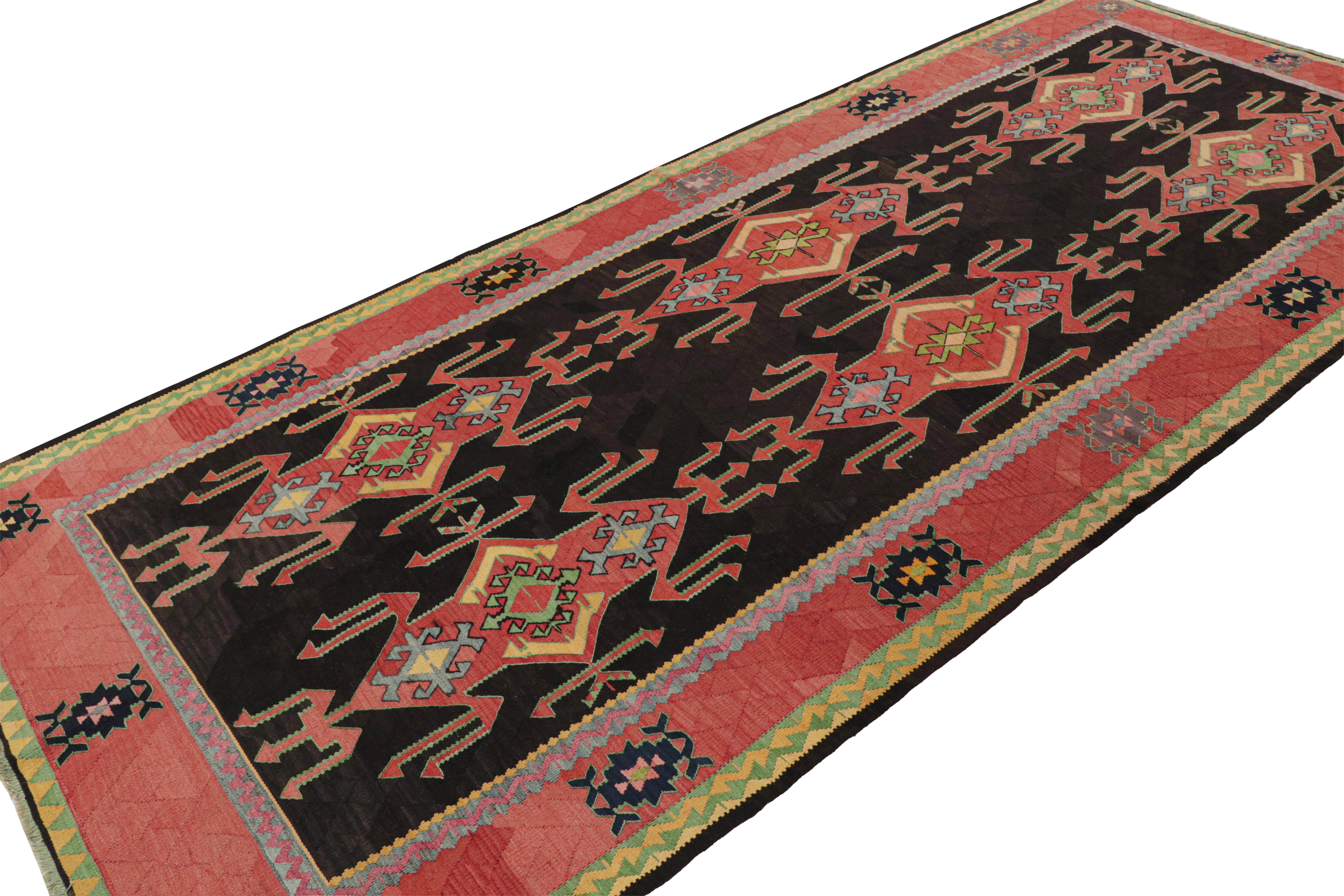 This vintage 5x11 Persian Kilim is the latest to join our Kilim & Flatweave collection. 

On the Design:

Handwoven in wool circa 1950-1960, the piece carries red patterns on a black field. The gorgeous tribal piece is fabulously unique in its scale
