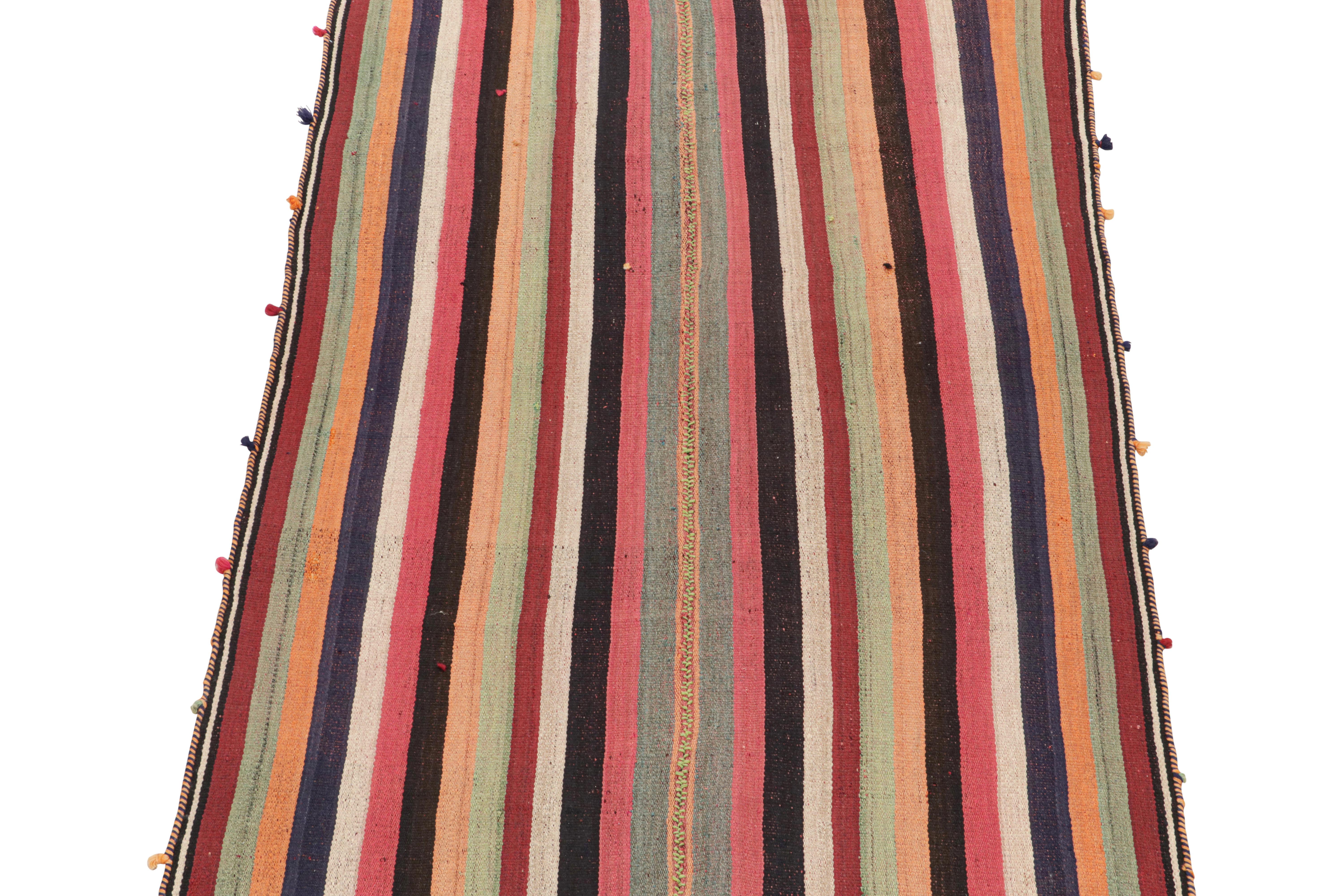 This vintage 5x7 Persian Kilim is a rare midcentury tribal rug, handwoven in wool circa 1950-1960. 

Its design most likely represents a Jajim-style Kilim–a flat-weaving technique in which multiple pieces are combined into one. This creates the