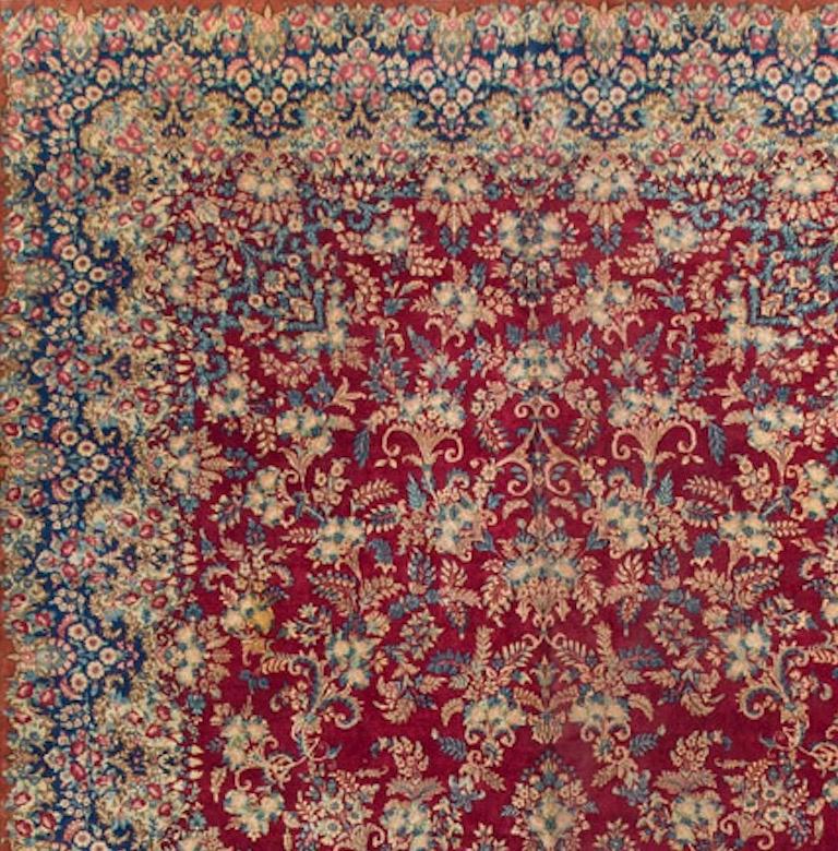 This rug is a striking piece of an unusual size. The field and border filled with floral motifs and creating a strong visual impression, that will translate in a room to create a truly wonderful look. Kirman is the capital of the province in south