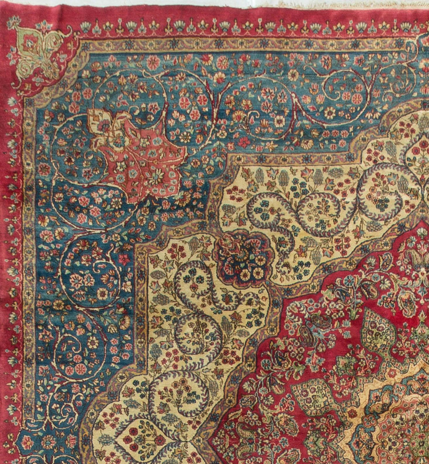 This square Kirman has all the attributes to look for in a rug. The fineness of the weave is matched by the design. The central red field surrounded by an ivory ring that is encompassed by a soft blue that blends to create its own border. Measures: