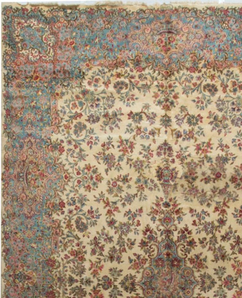 This rug is in the traditional Kirman style, the ivory field is filled with colorful floral designs all enclosed by a soft blue border repeating the floral theme. Kirman is the capital of the province in south Persia of the same name. Situated 2000