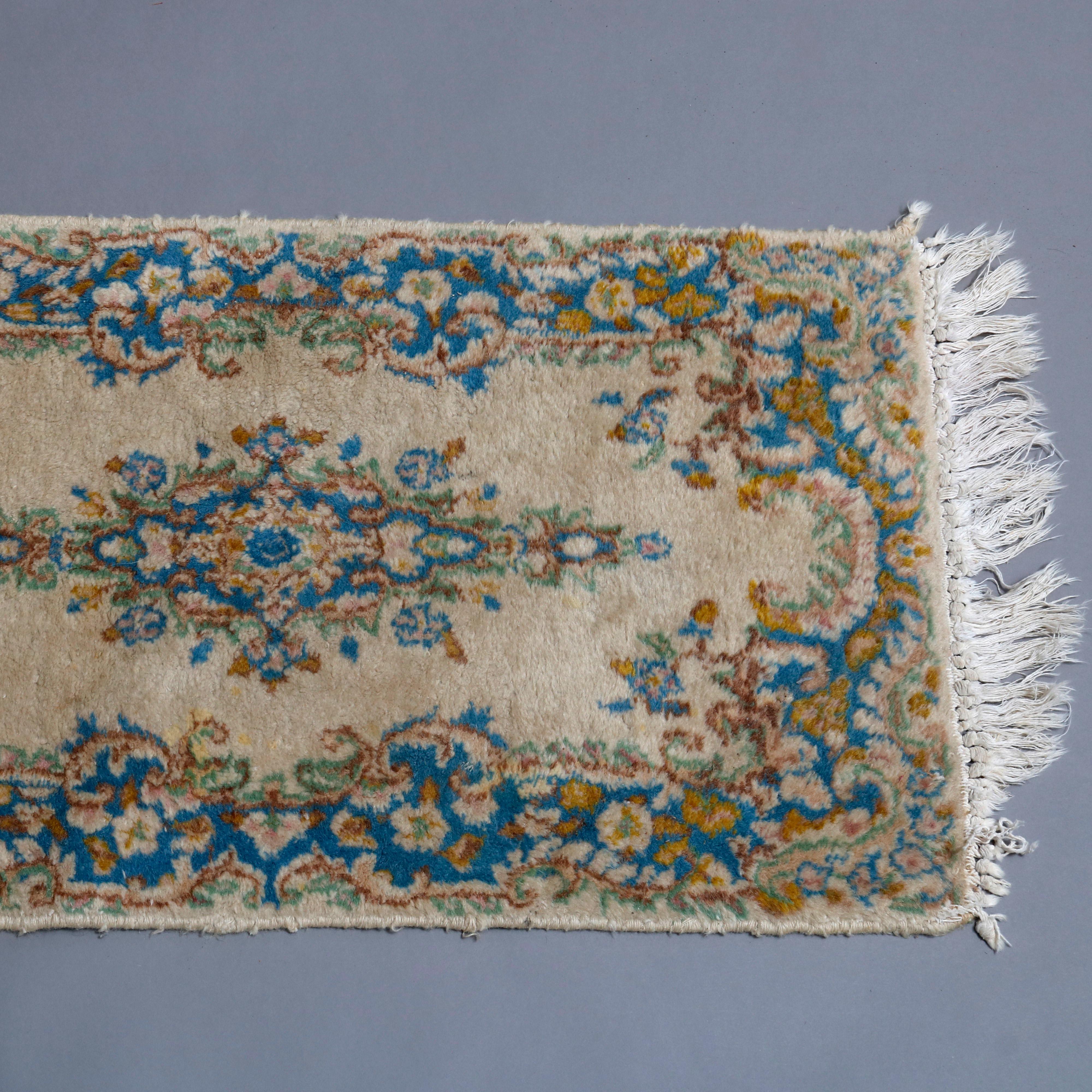 A vintage Persian Kirman oriental area rug offers central foliage pendant medallion and bordering on cream ground, original labels en verso as photographed, circa1950.


Measures: 38