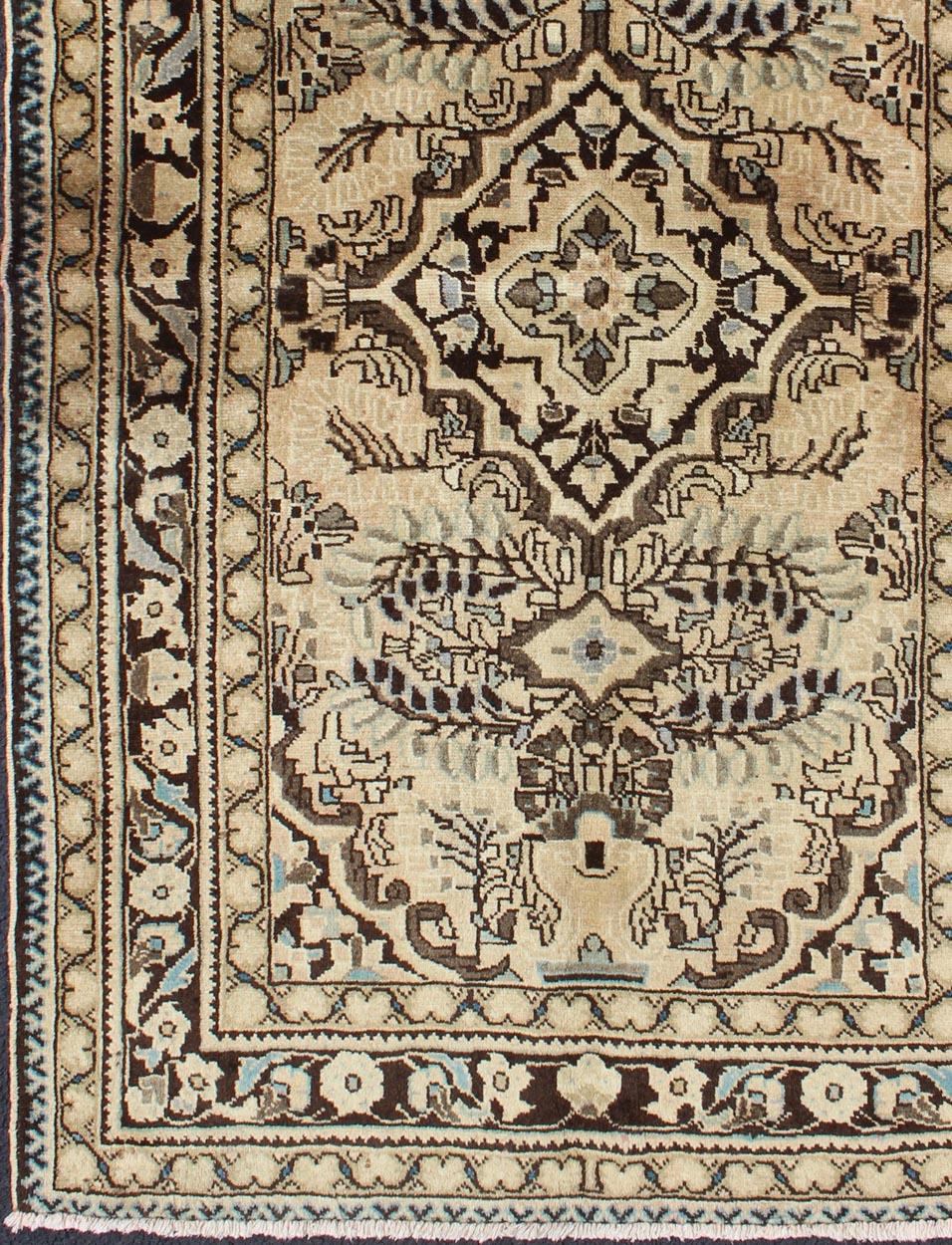 This vintage Persian rug features a center medallion design in a neutral color palette with brown outlines. 
Measures: 3'7 x 5'10.