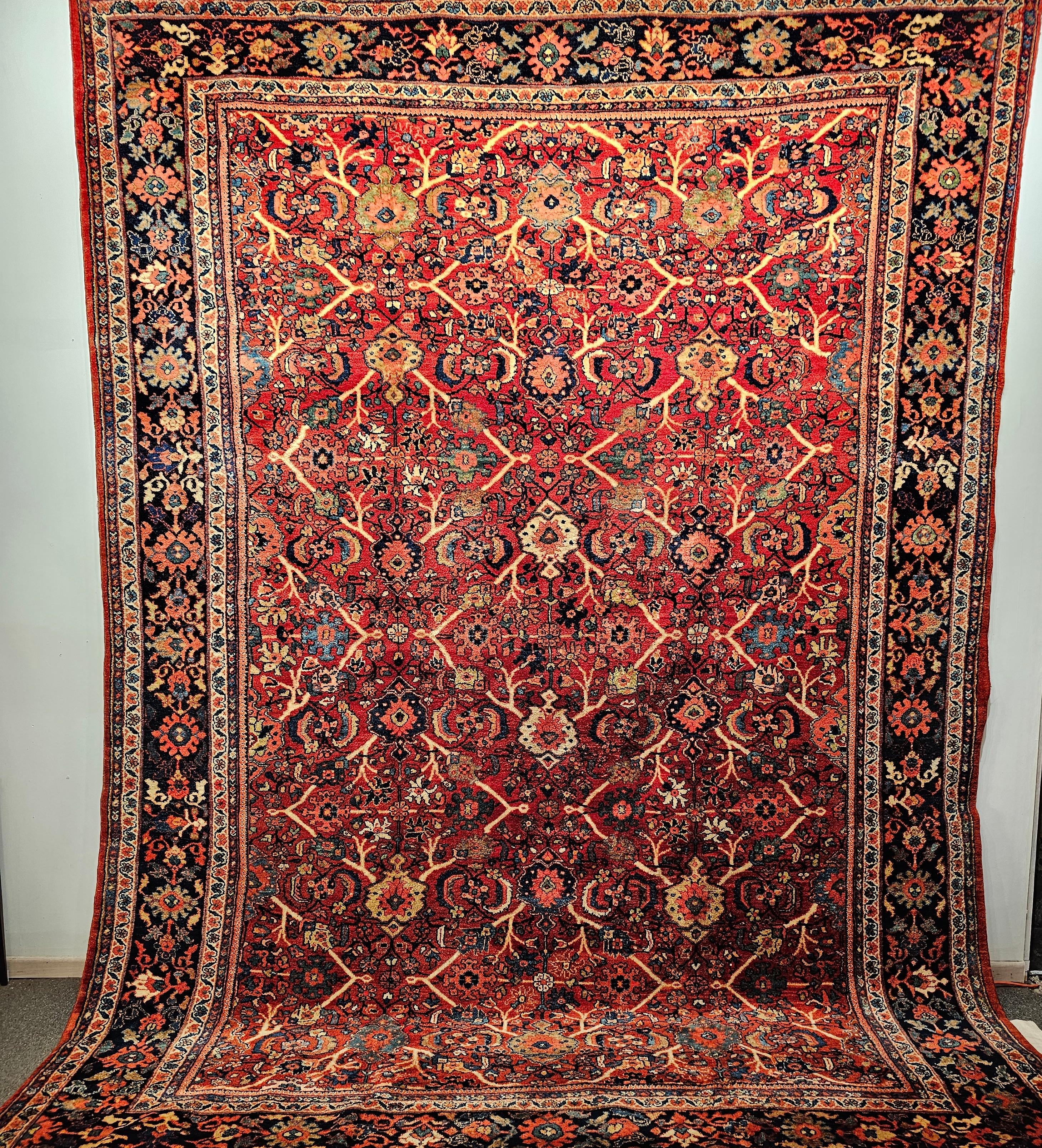 One of the most magnificent Persian Mahal Sultanabad rugs in our collection from the early 1900s.  The rug is in a large-scale all-over design pattern with geometric forms connected via scrolling lines.  The rug has a rust-red field color with