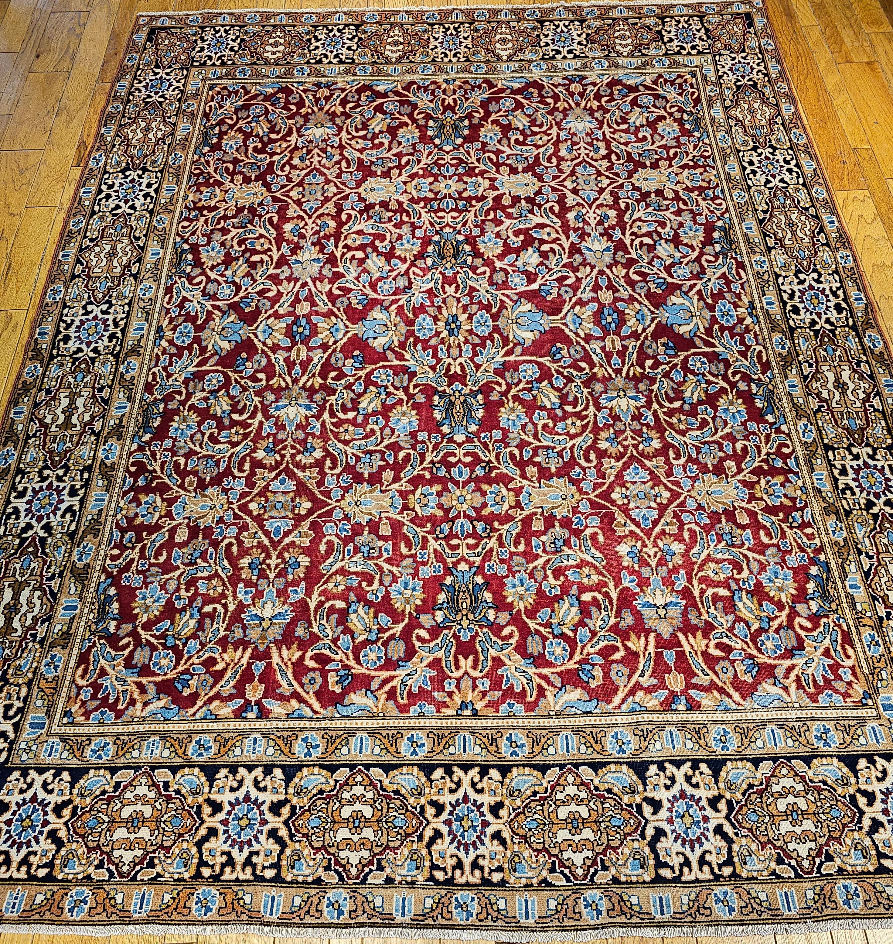 Vintage Persian Mahal Sultanabad room size rug in an allover design circa the mid 1900s.  The field is a rich red color with large scrolls reminiscent of the famous Sultanabad rug of the mid-1800s with large designs in baby  blue, cream, and light