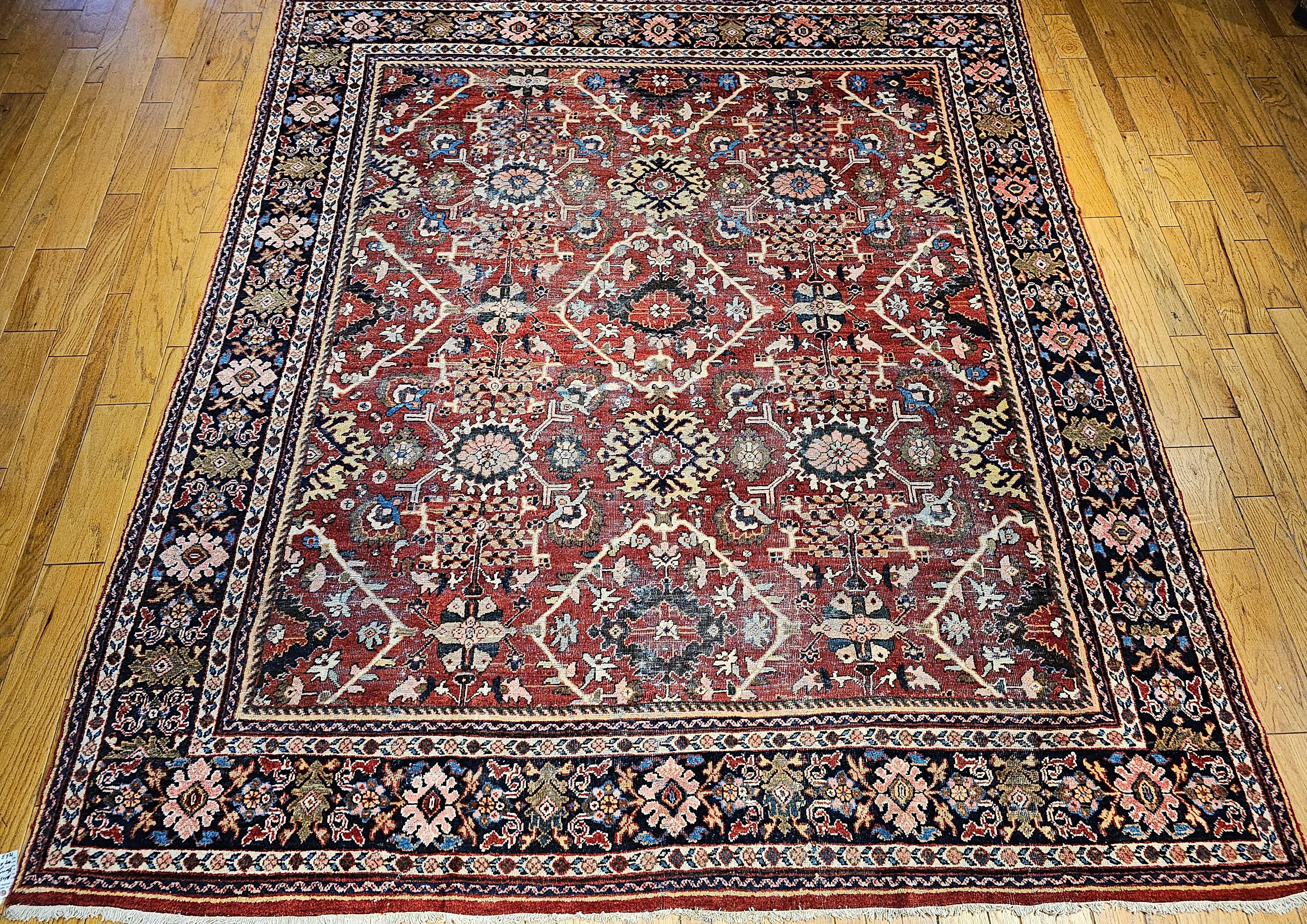 Vintage  Persian Mahal Sultanabad rug in an allover pattern in dark red and navy blue from the late 1800s.   It has an all-over design that consists of large geometric forms in beautiful bright colors of red, blue, pink, green, brown, and yellow set