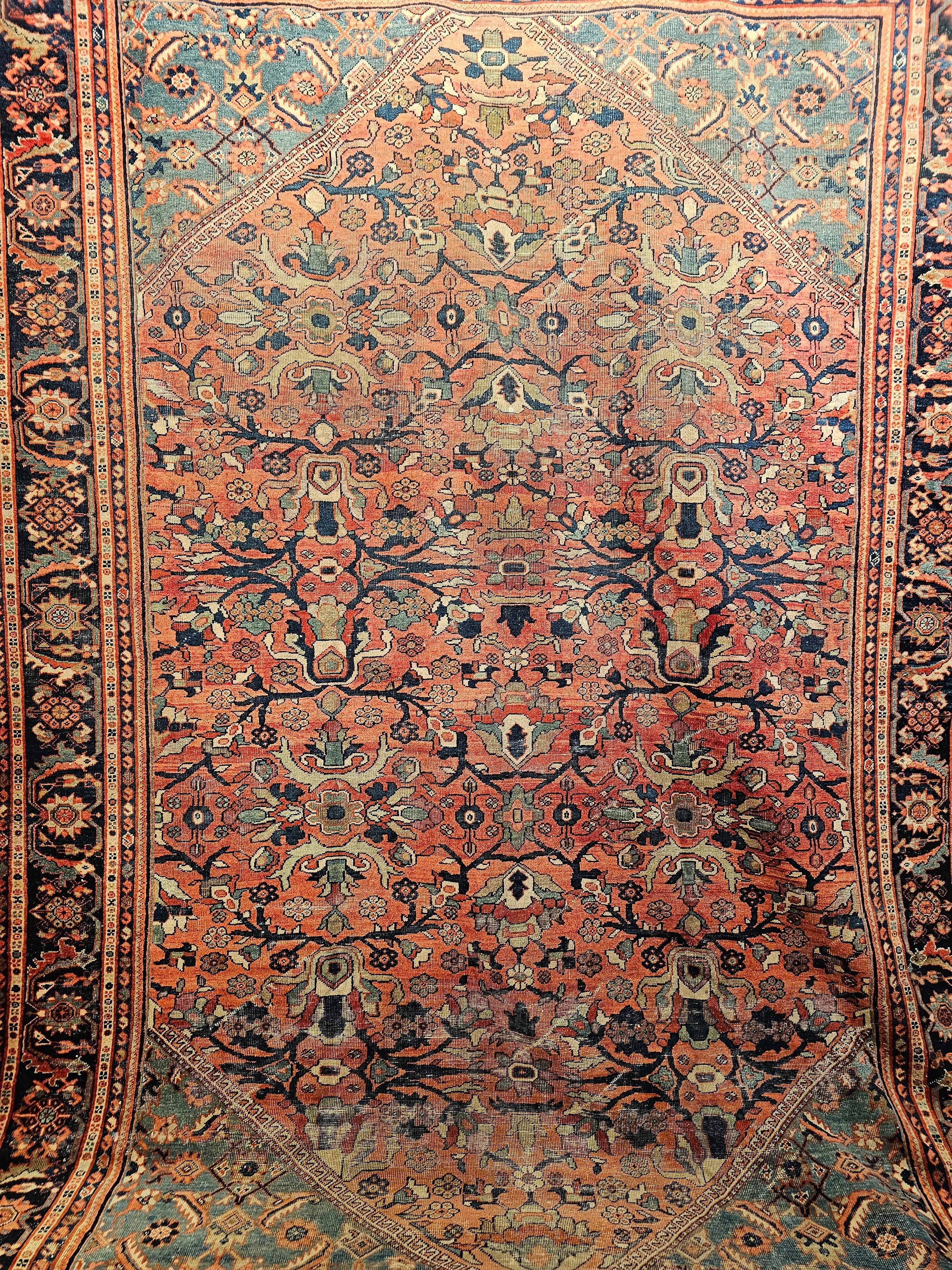 Vintage Persian Mahal Sultanabad carpet from the late 1800s with a large pattern allover design in a red field and a very unique turquoise green/blue corner  spandrels.  . The very unique large-format designs of green, blue, ivory, and red add to