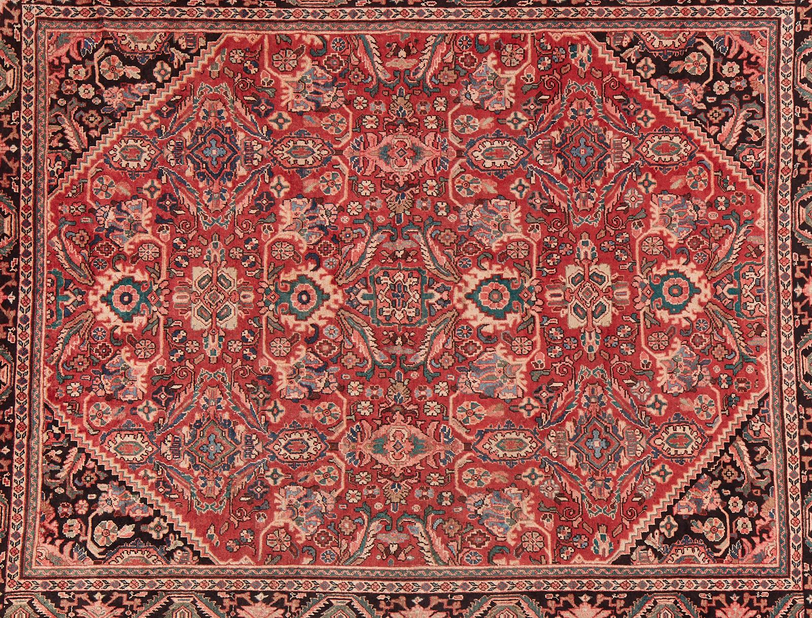 Modern vintage Persian Mahal hand-knotted wool rug featuring an intricately decorated ruby red field with triangular corners. Beautifully crafted with dazzling pinks in the floral borders. From an estate in San Francisco, CA.