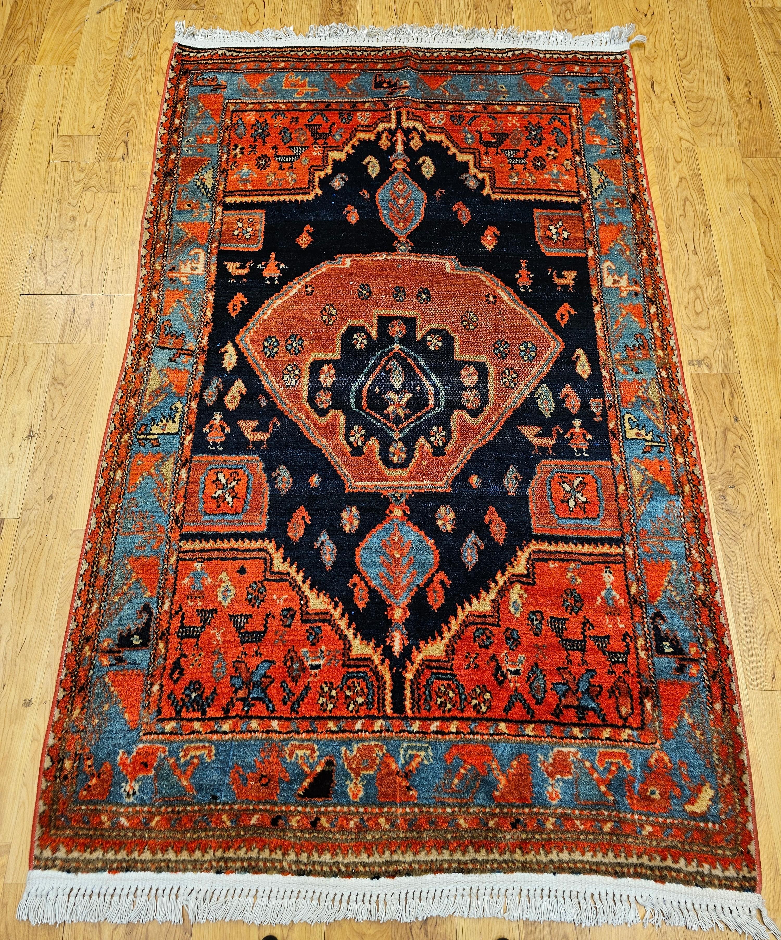 Un bellissimo tappeto persiano Mission Malayer con un disegno a medaglione davvero unico nei colori blu navy, turchese e terracotta dei primi anni del 1900.   Un grande esempio di tessitura di villaggio con il disegno di forme umane e animali.  Il