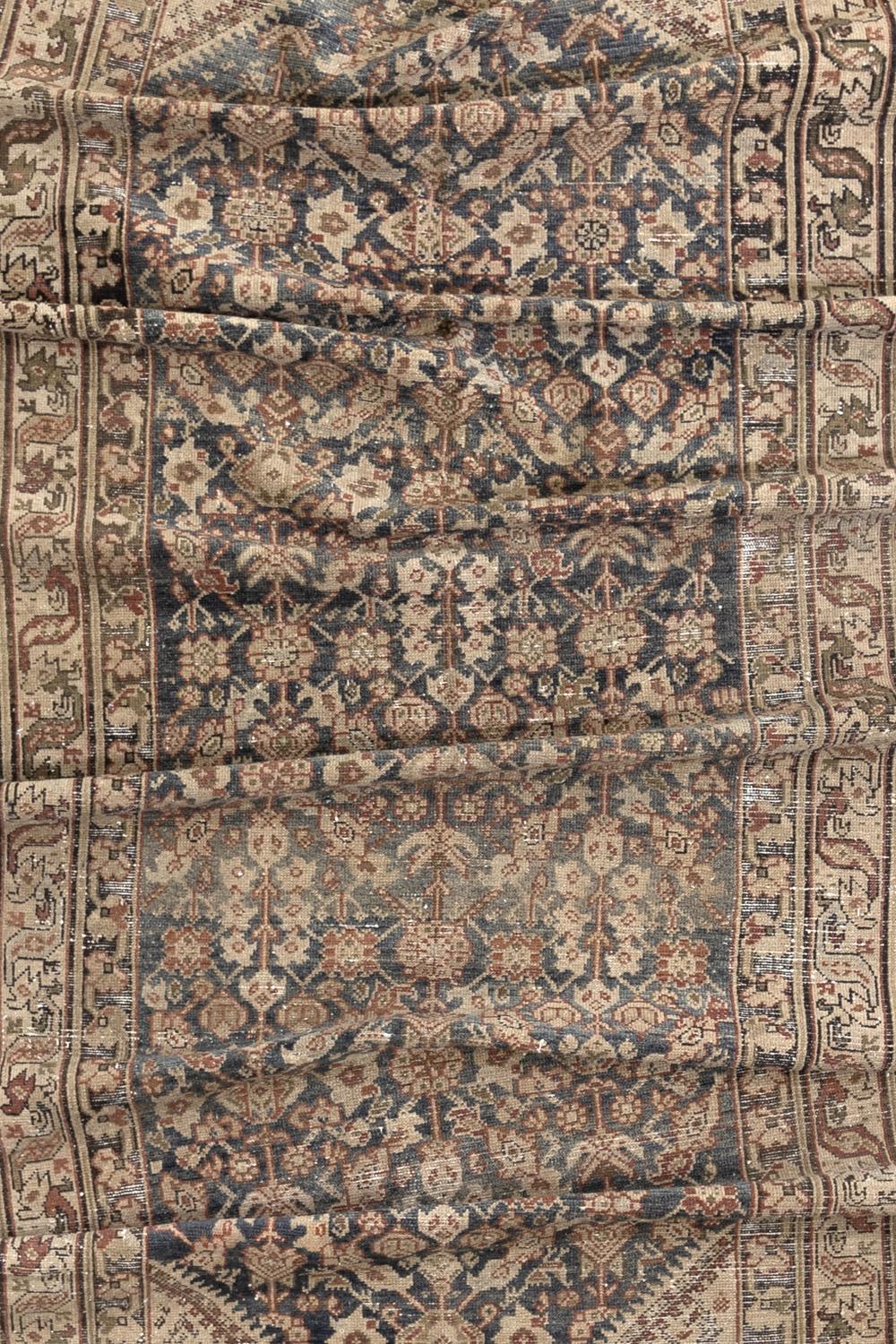 Age: Circa 1920

Colors: navy, rust, pale tan, olive, khaki

Pile: low-medium 

Wear Notes: 3

Material: wool on cotton

Persian Malayer gallery rug woven in the first quarter of the 20th century. Beautiful colors that are earthy and soft. 

Wear