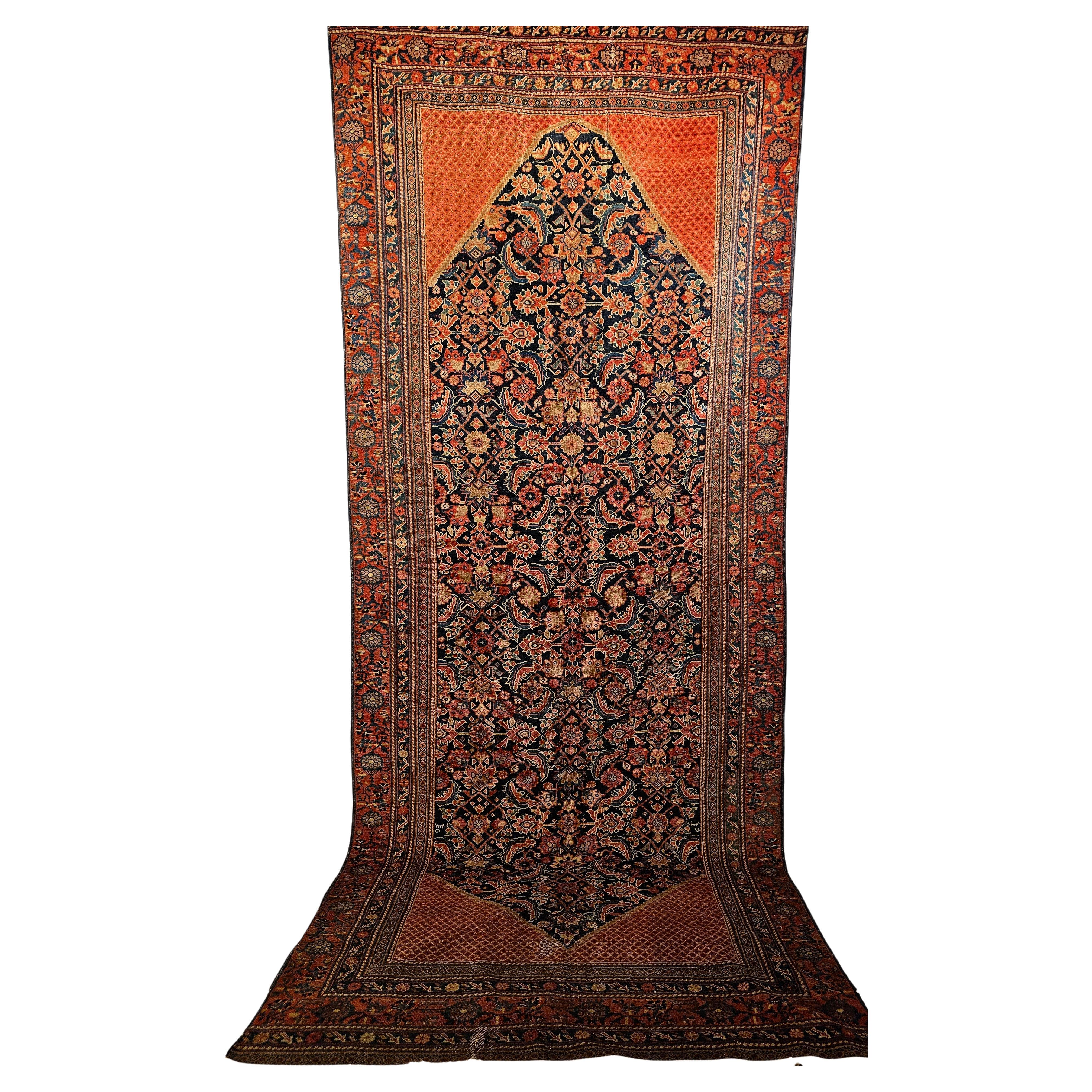 A vintage Persian Malayer gallery or corridor rug woven in the first quarter of the 1900s has a beautiful allover Herati pattern set in a navy blue background.The Malayer gallery rug has a beautiful border in red with very unique geometric design in