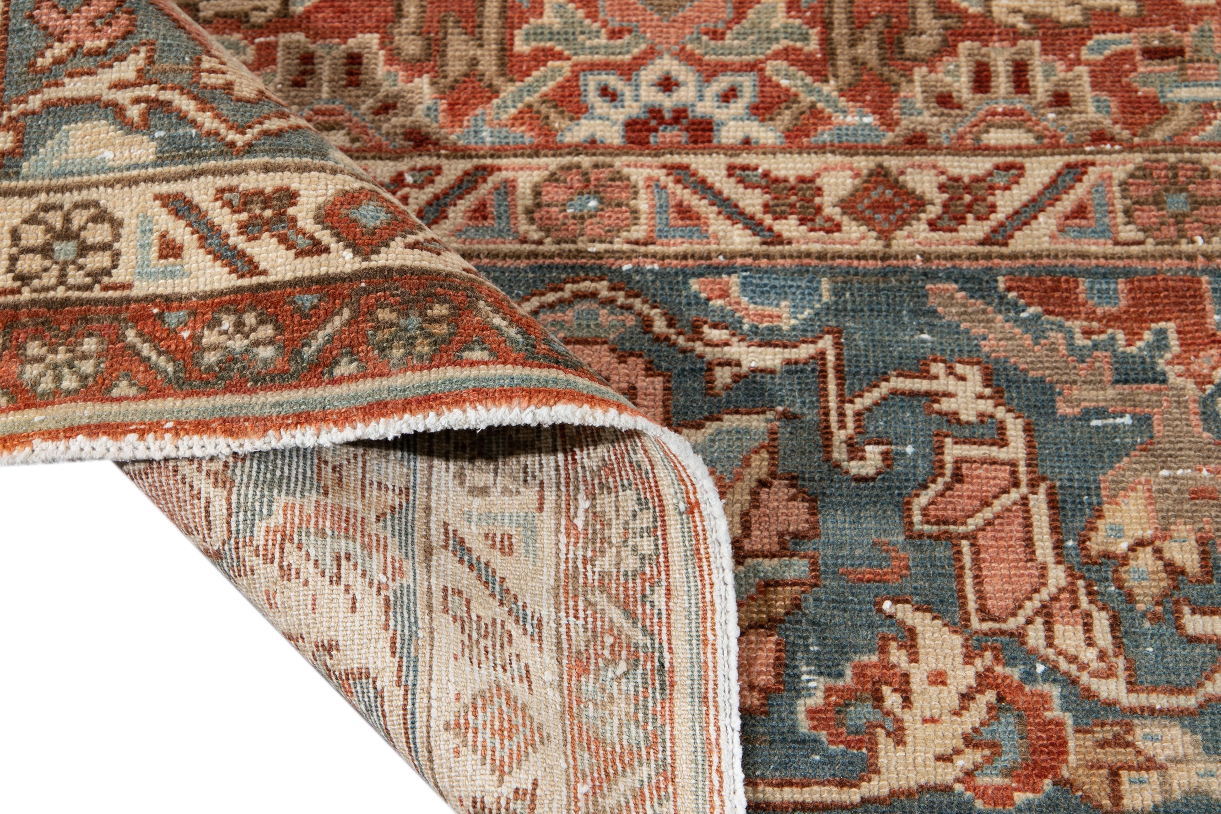 Beautiful vintage Persian Malayer hand knotted wool rug with a rush field. This Malayer rug has accents of blue and brown in an all-over geometric Botanical design.

This rug measures: 10'3