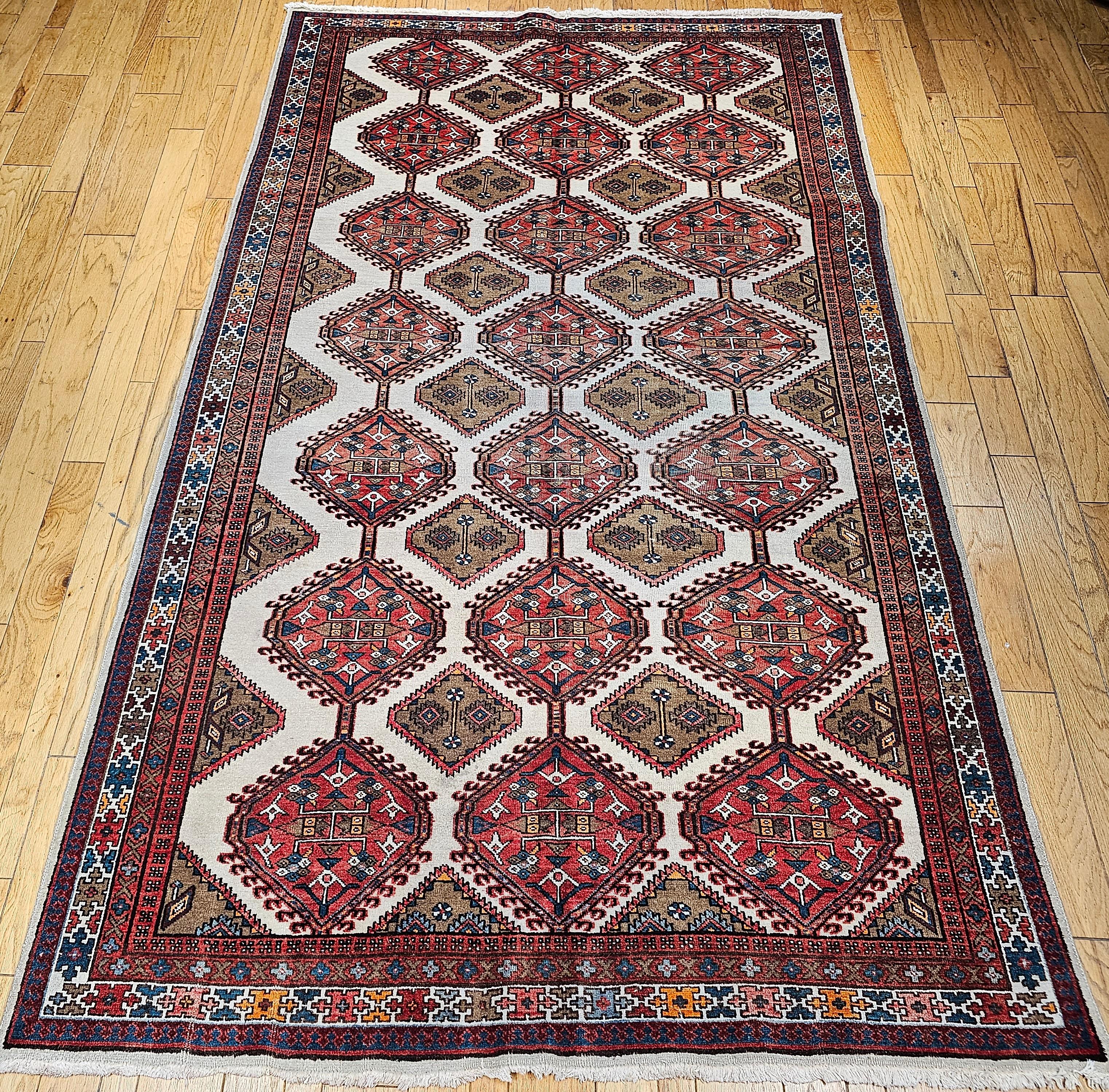Vintage Persian Malayer in an all over geometric pattern in ivory, camelhair, red, brown, and green.   This beautiful Persian Malayer is a room size or a gallery rug that has an ivory color background with a large geometric pattern. The rug has