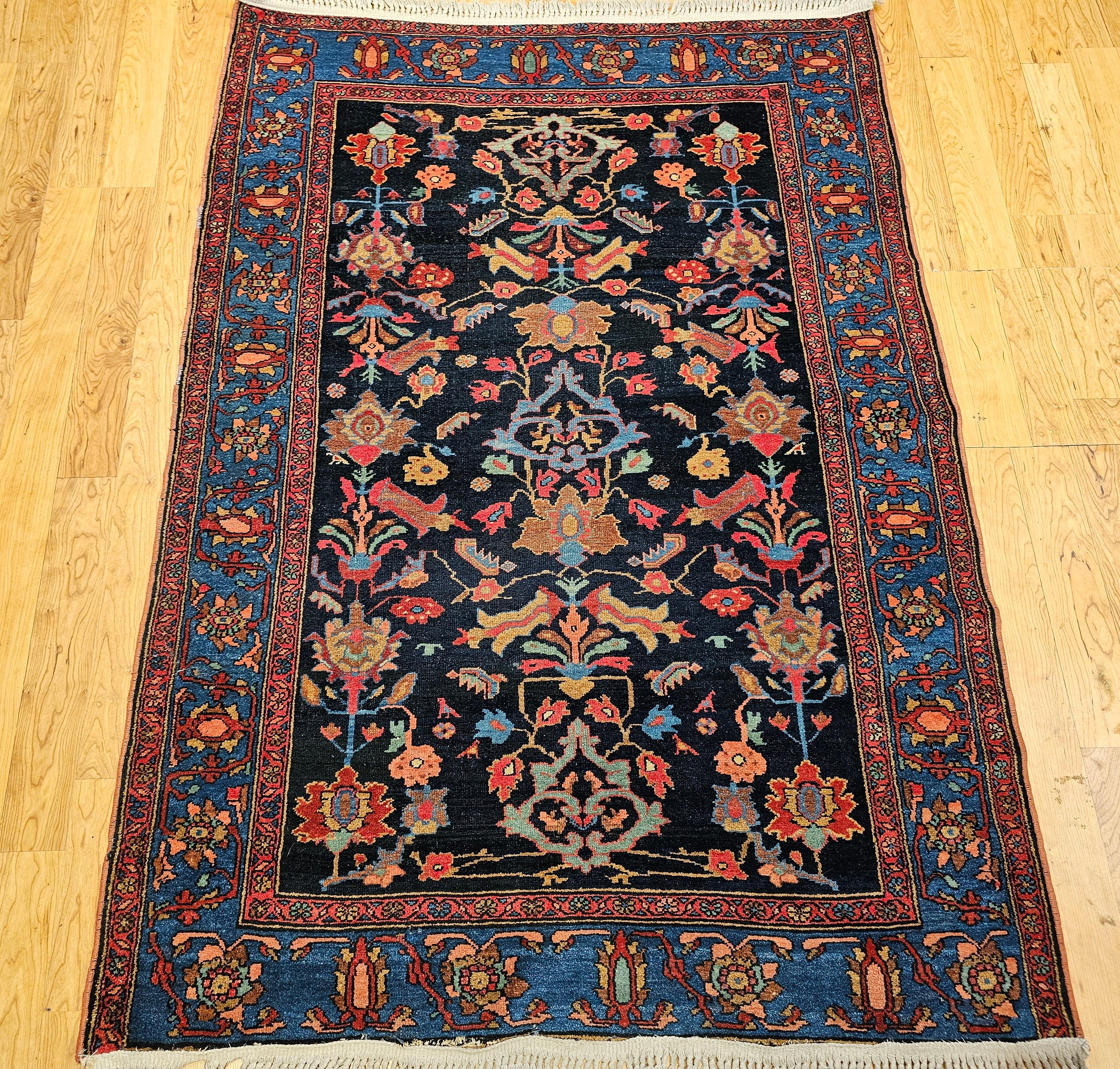 Experience the enduring artistry of Persian weaving with this exceptional Vintage Persian Malayer area rug, dating to the early 1900s. This captivating piece features an all over geometric pattern set against a striking midnight blue background,