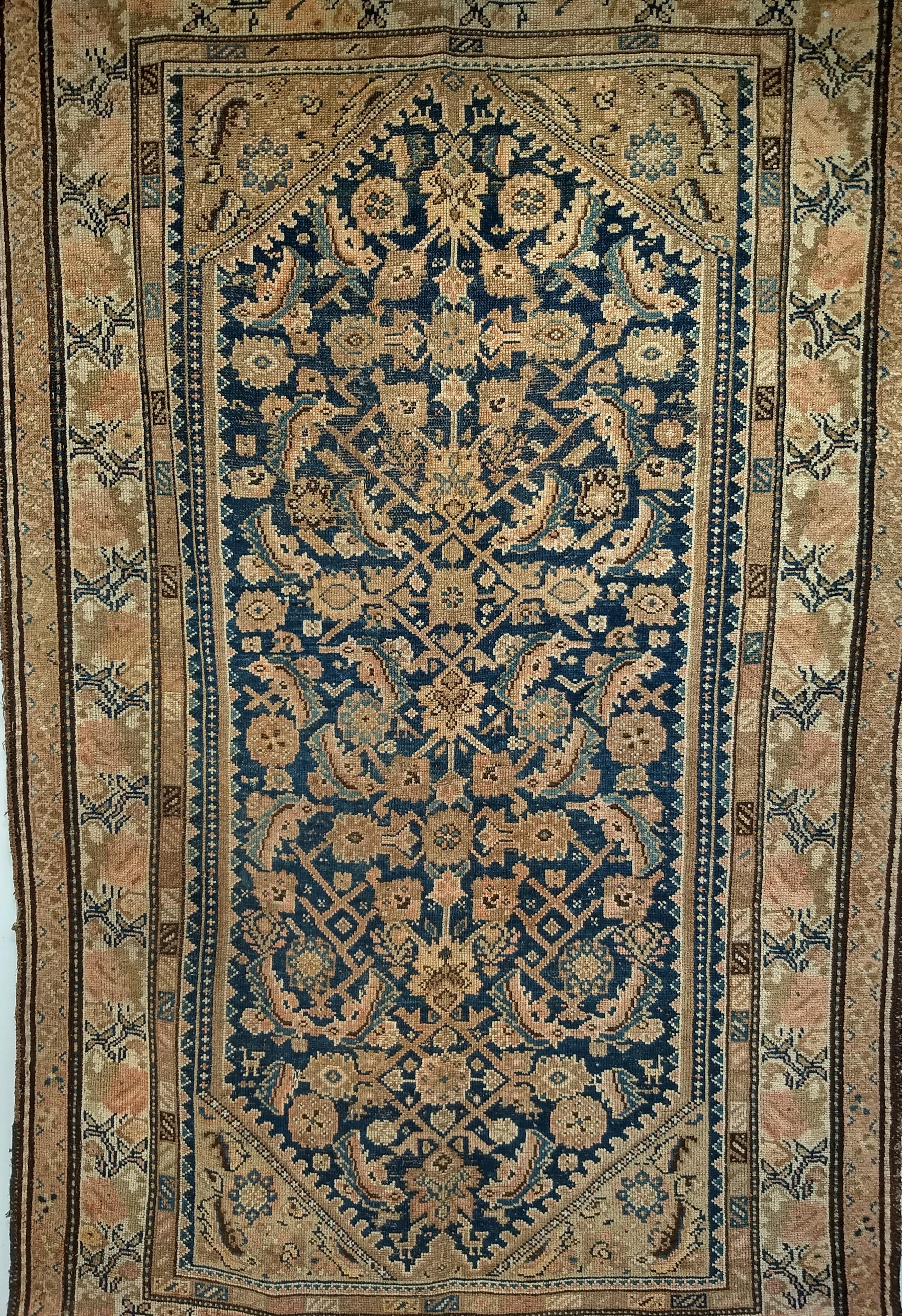 Vintage Persian Malayer in an allover Herati design area rug from the late 19th century.  The Malayer rug has an allover Herati pattern design on a dark navy blue field and a cream color border with design colors in brown and French blue. The
