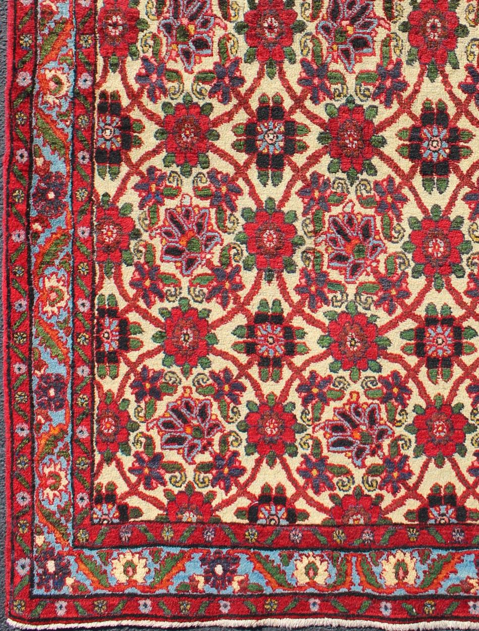 Vintage Persian Malayer rug with floral pattern, rug H-209-4, country of origin / type: Persian / Malayer, circa mid-20th Century.
This Persian Malayer from mid-20th century Iran features an all-over floral pattern in vivid colors of red, green and