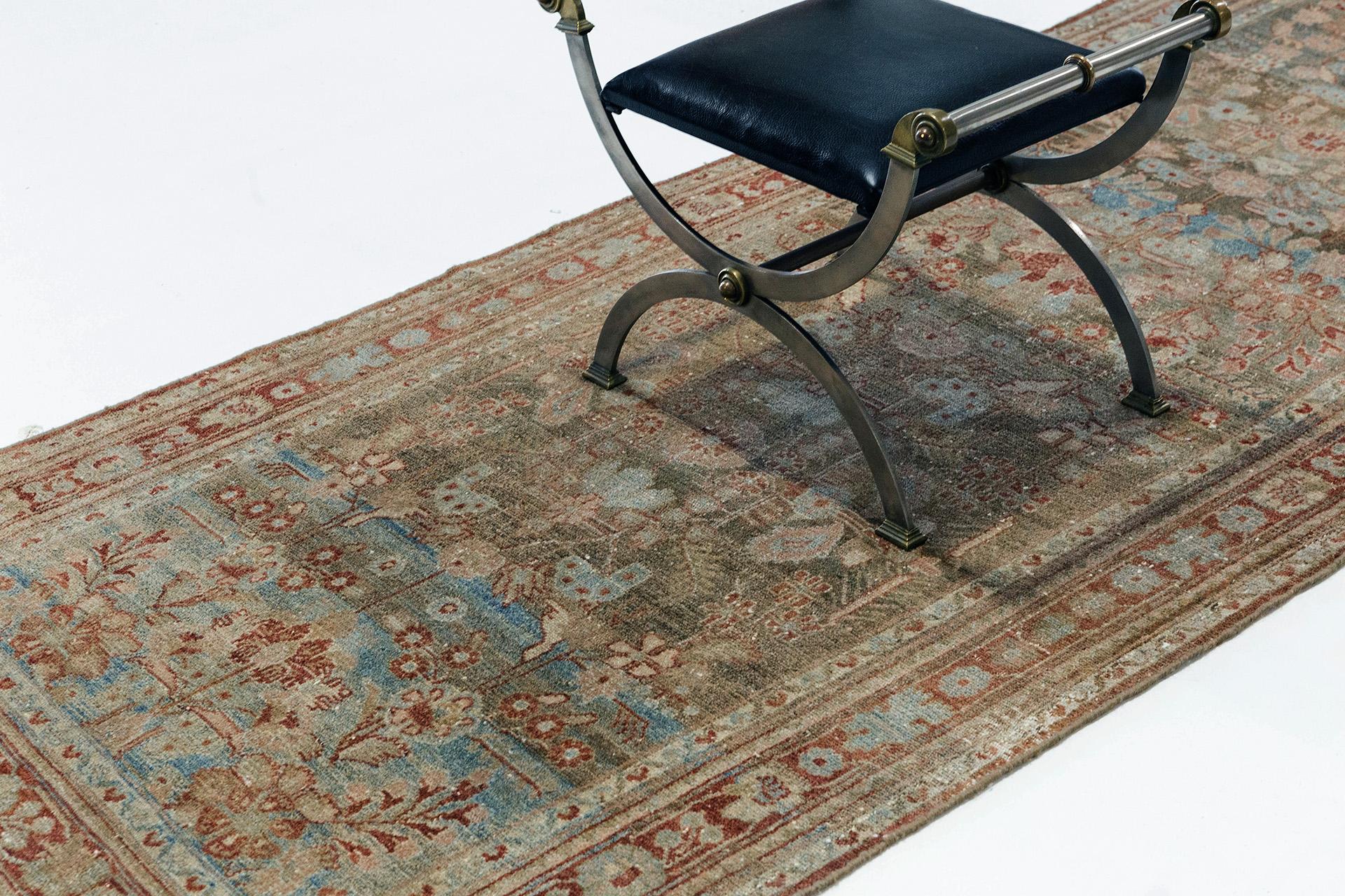 A beautiful Malayer runner with beautiful traditional Persian designs in rust, blue, and natural colors. This authentic Persian Malayer from Iran consists of tribal motifs both in its field and surrounding borders. In Malayer and the small villages