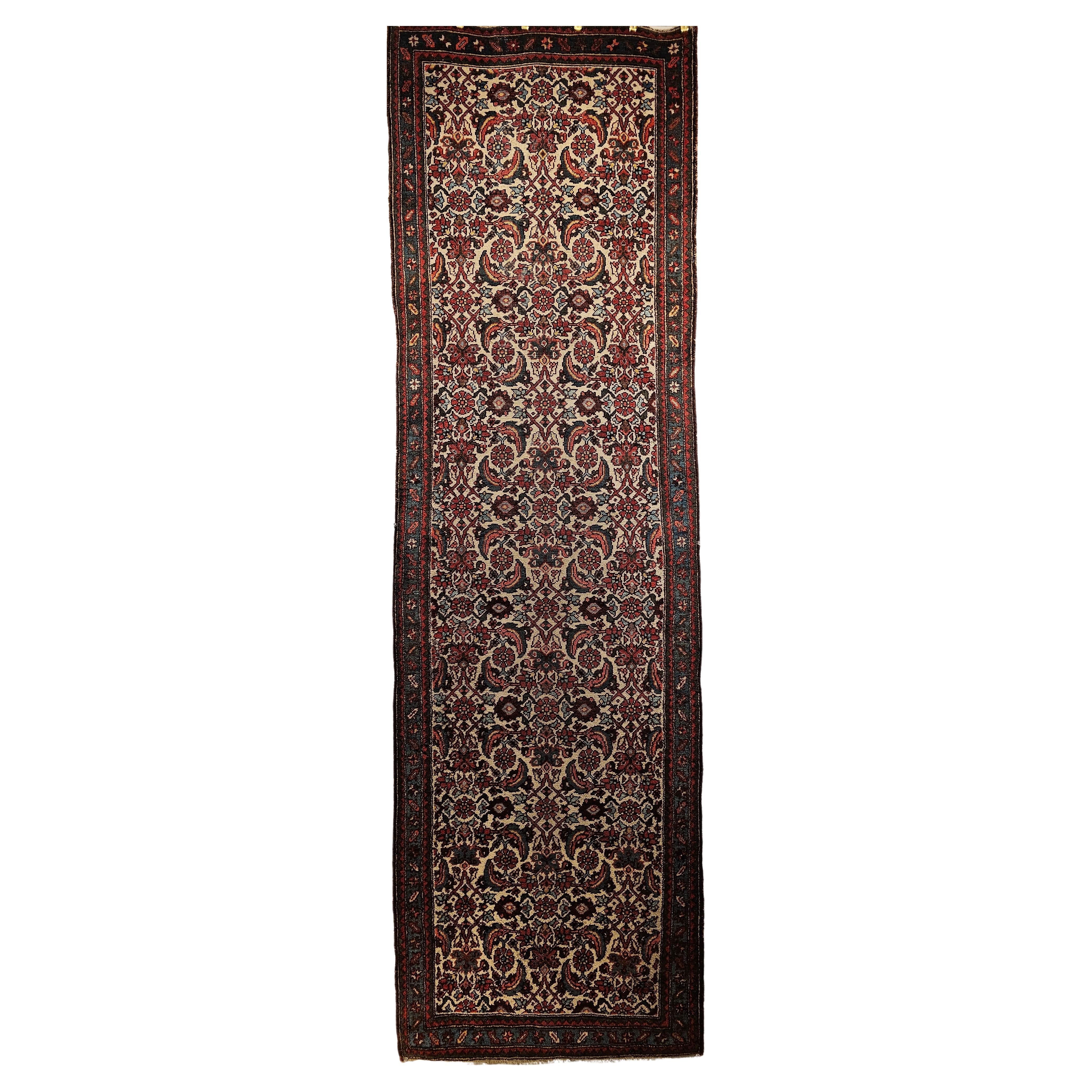  A vintage Persian Bidjar runner in an allover Herati pattern in ivory, French blue, brown, and red colors from the 1st quarter of the 20th century.  The rug has a classic Herati design set in a very rare and desirable ivory background. The design