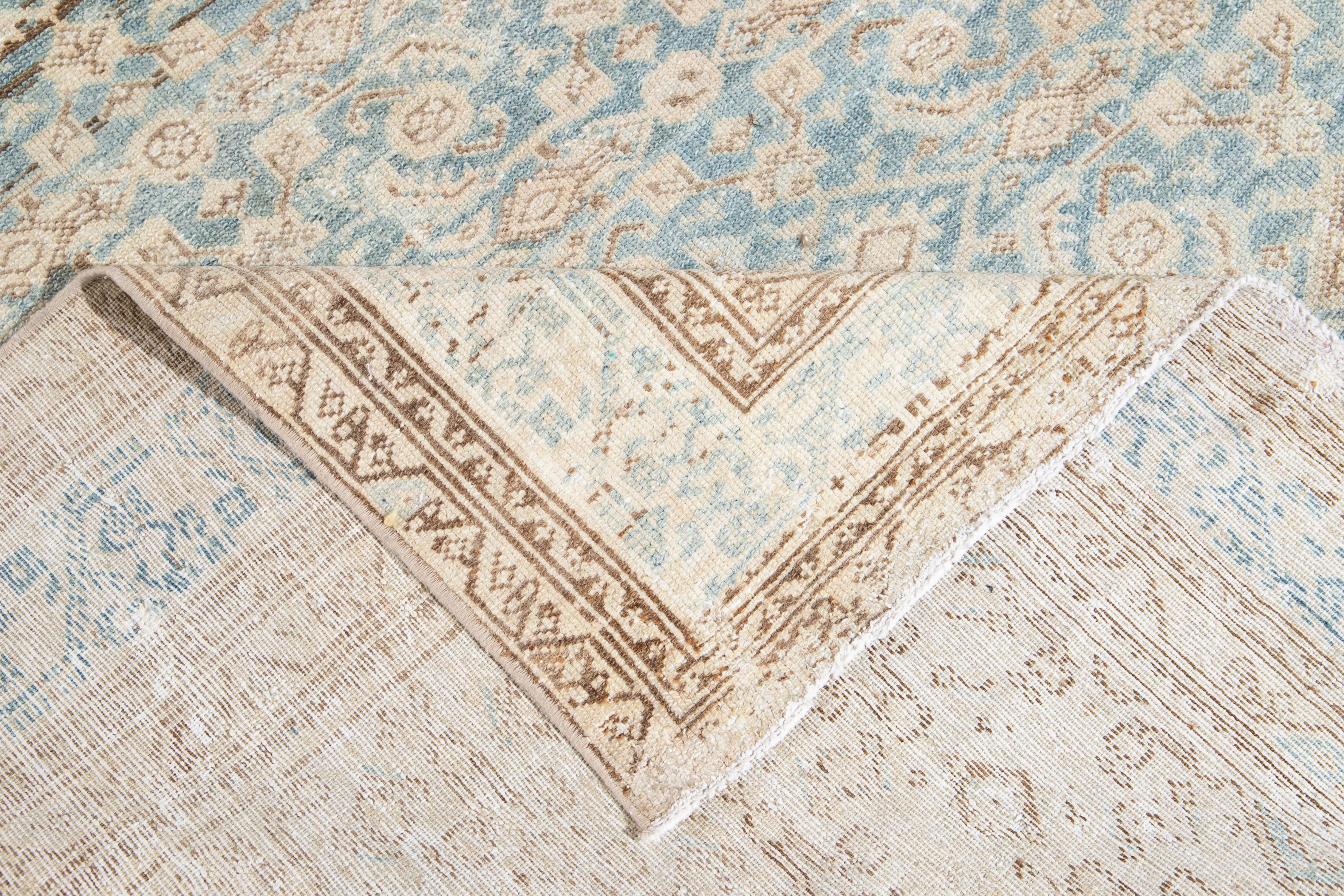 Beautiful vintage Persian Malayer hand knotted runner with a blue field, beige, and ivory accents in an all-over geometric motif design, with muted neutral tones wool rug!

This rug measures: 7'5