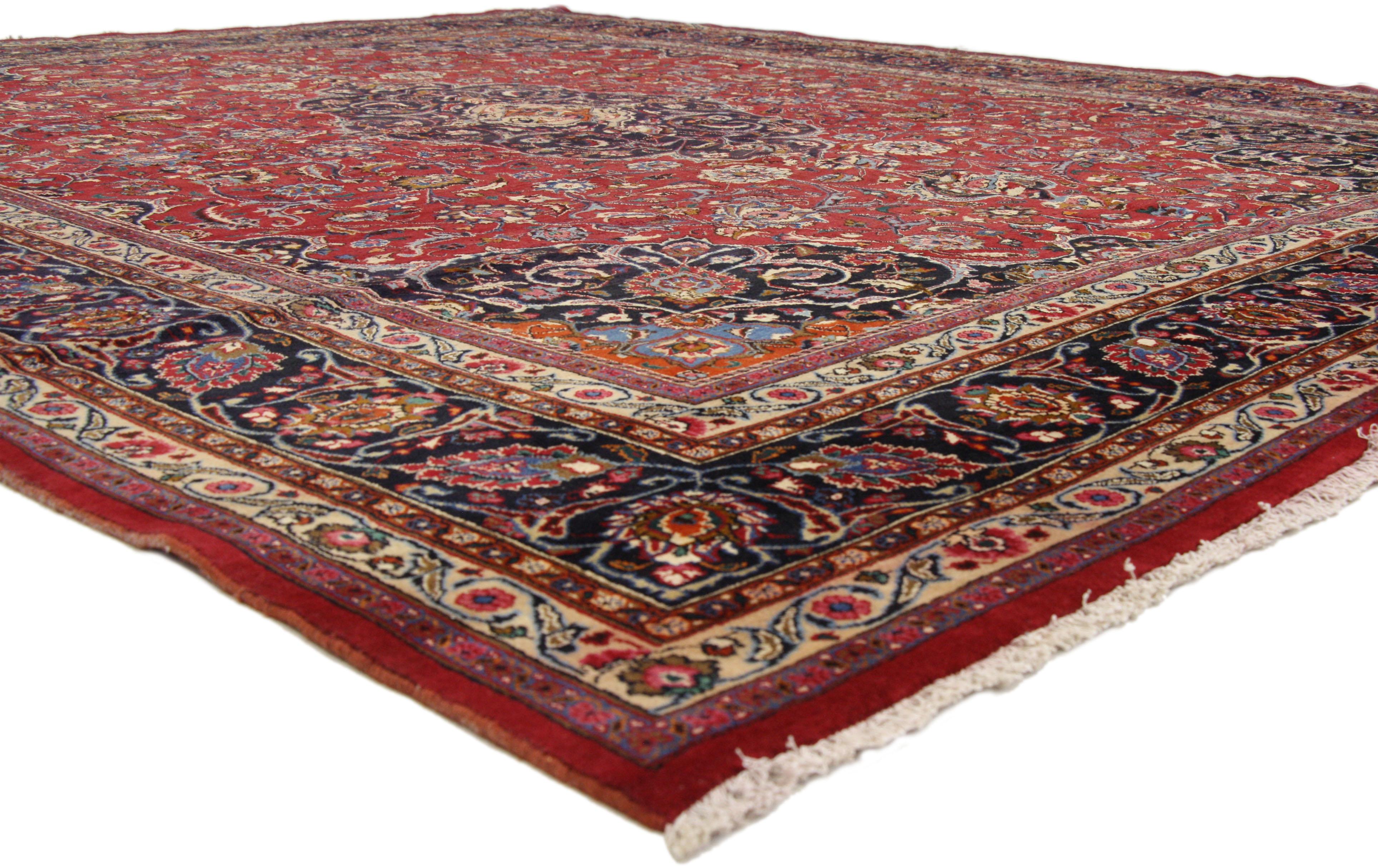 76216, vintage Persian Mashhad Area rug with traditional style. This hand-knotted wool vintage Persian Mashhad rug features a cusped Mashhad medallion in a field of palmettes, feathers, serrated leaves and blooming flowers. The central medallion is