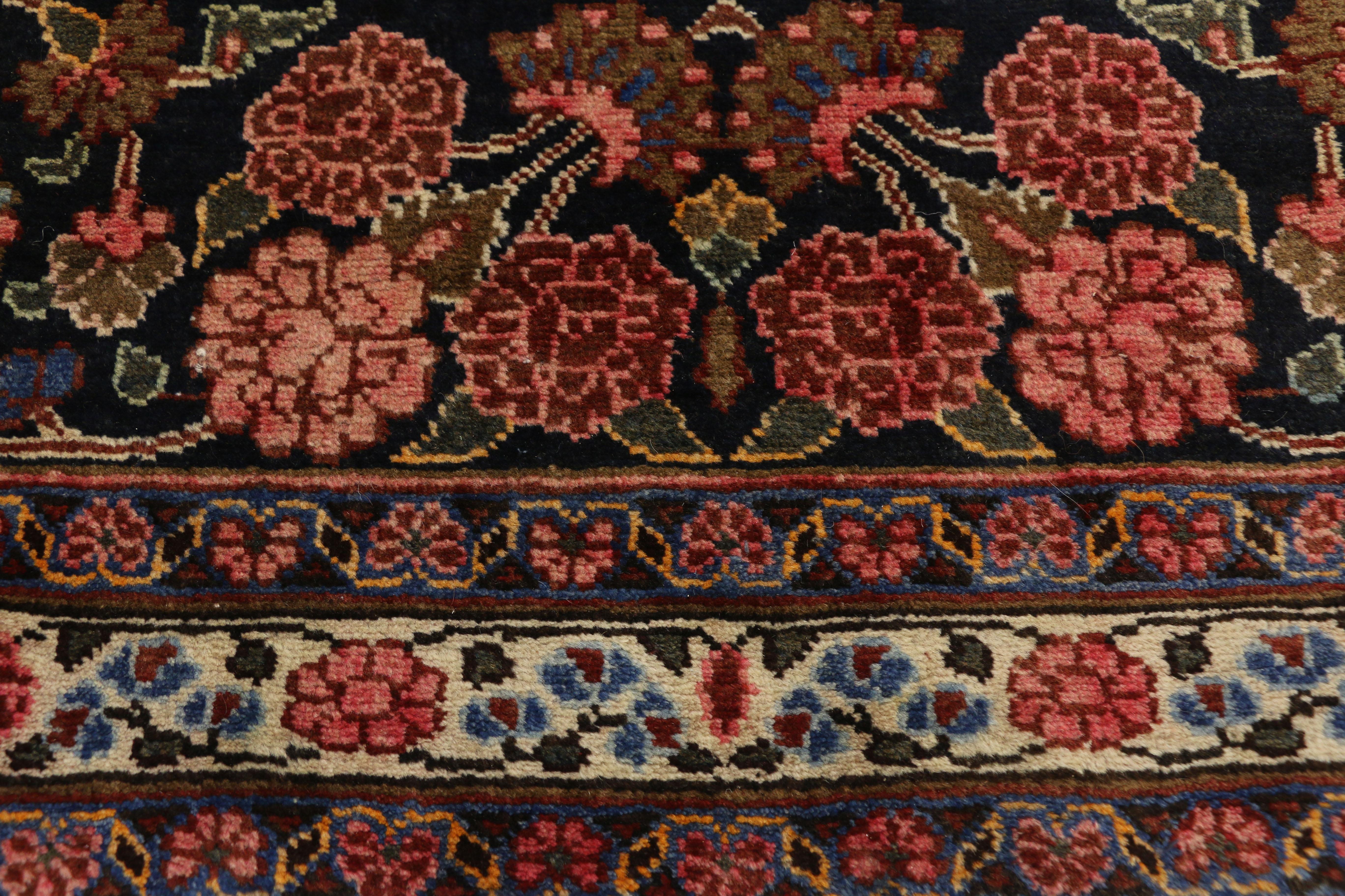 75141, vintage Persian Mashhad Area rug with traditional style. This hand-knotted wool vintage Persian Mashhad rug features a 16-point Mashhad medallion floating among bouquets of blooming palmettes. The central medallion is surrounded by