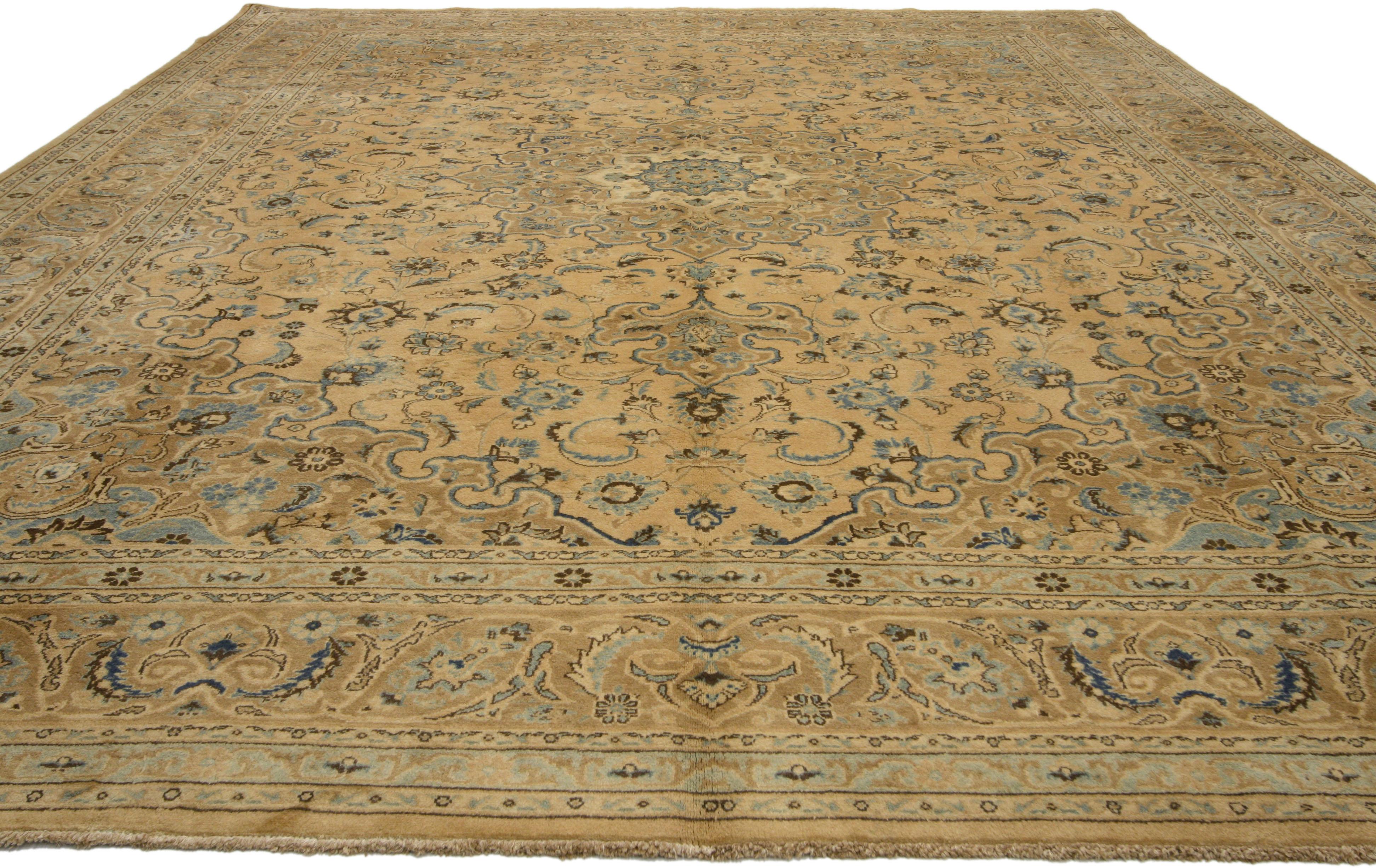 75890, vintage Persian Mashhad Area rug with traditional style. This hand-knotted wool vintage Persian Mashhad rug features a 16-point Mashhad medallion in a field of palmettes, feathers, serrated leaves and blooming flowers. The central medallion