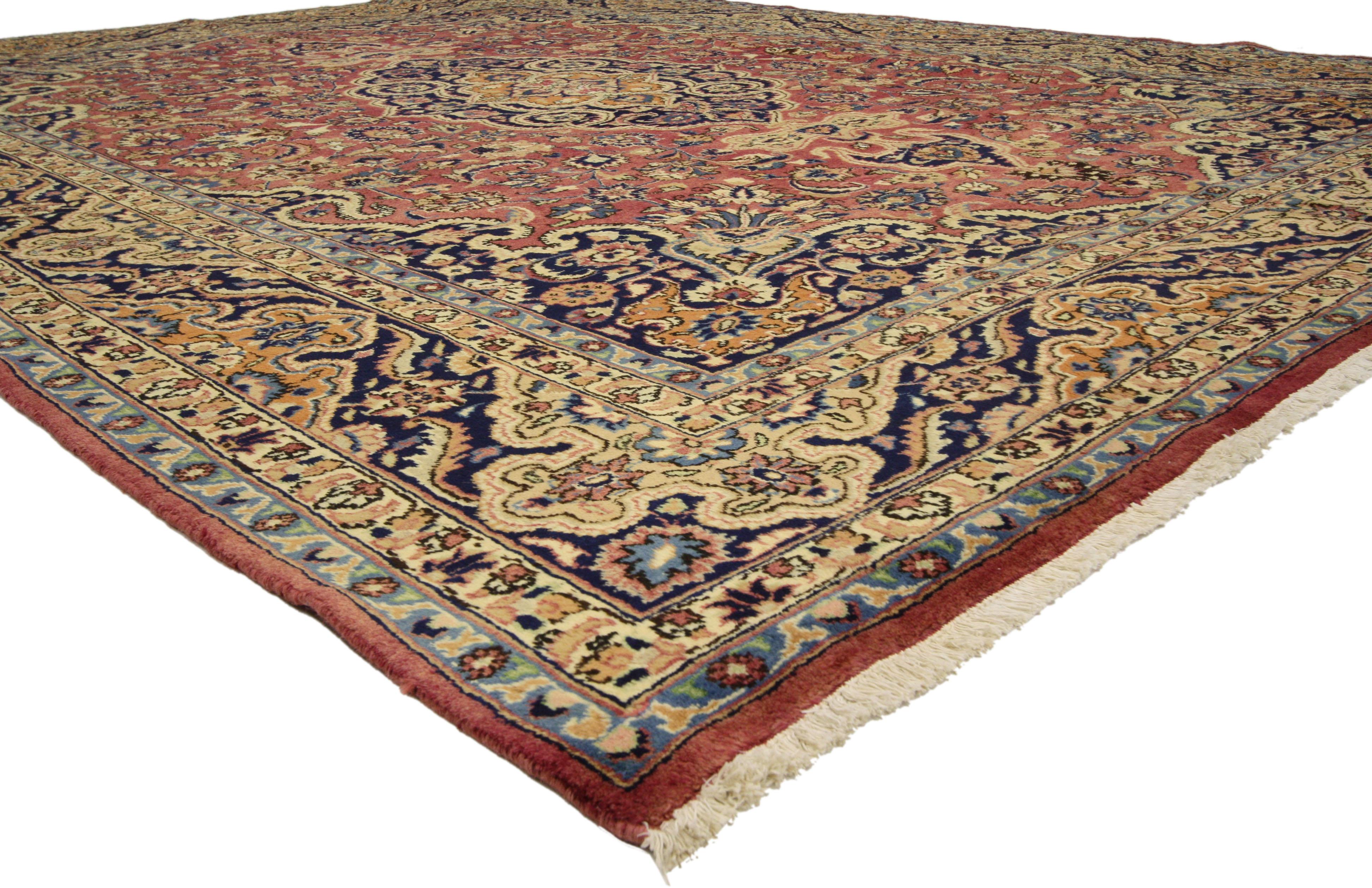 76310 Vintage Persian Mashhad Area Rug with Arabesque Baroque Regency Style. This hand-knotted wool vintage Persian Mashhad rug features a cusped lozenge Mashhad medallion flanked by palmette finials in a field of palmettes, feathers, serrated
