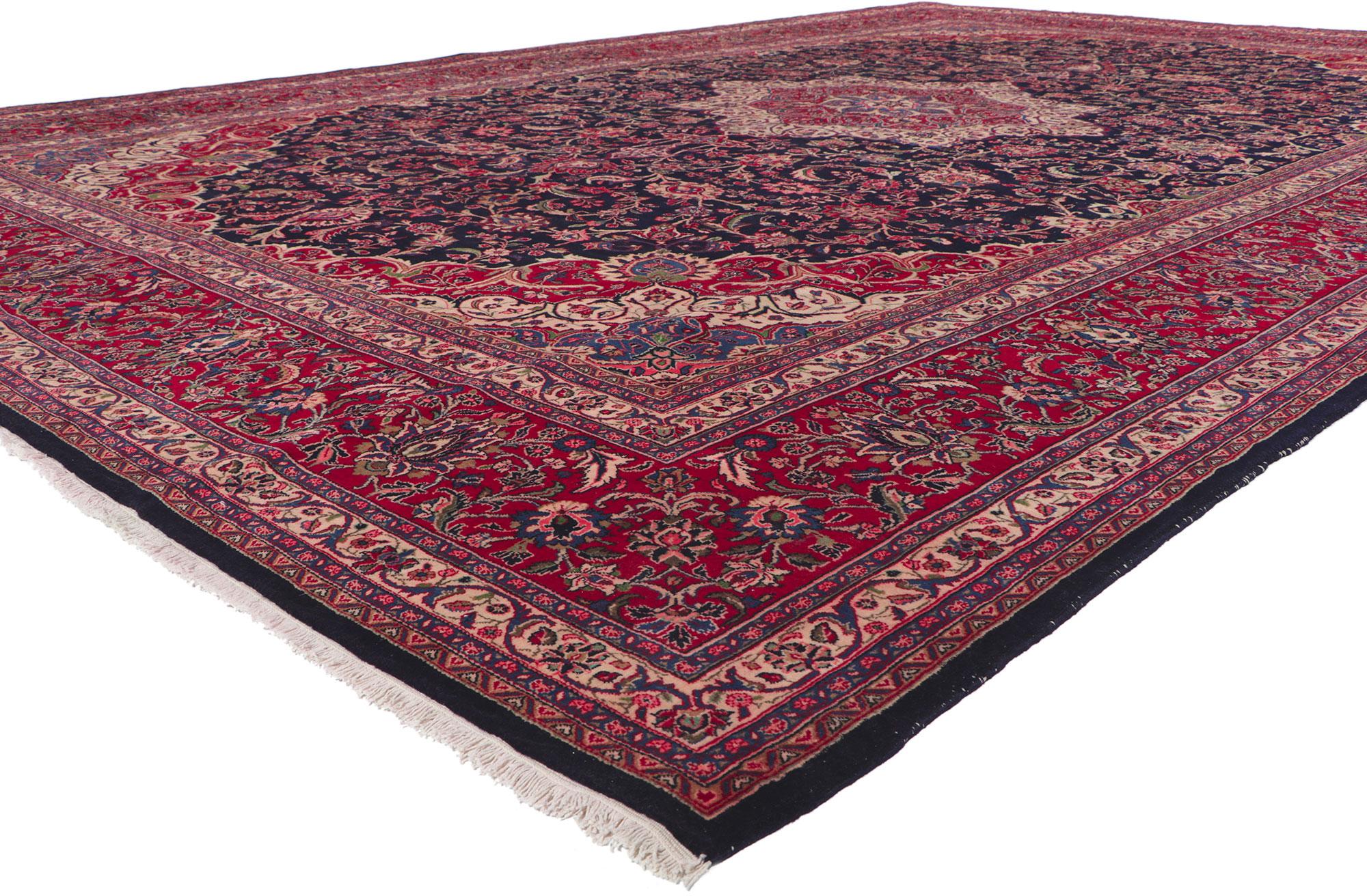 61204 Vintage Persian Mashhad Rug, 11.02 x 16.05.
With timeless appeal and ornate decorative detailing, this hand knotted wool vintage Persian Mashhad rug is a captivating vision of woven beauty. The midnight colored field highlights an eight-point